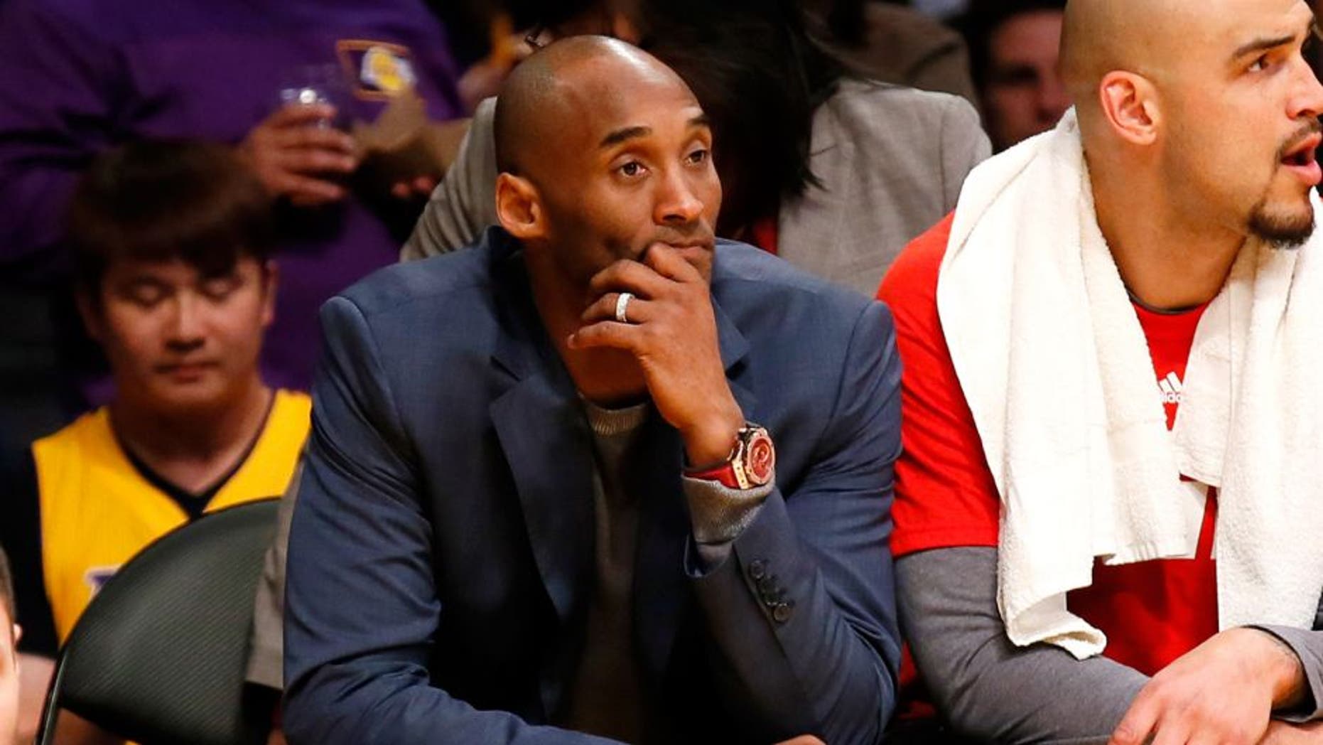 Los Angeles Lakers' Kobe Bryant sits on the bench during the first half of the team's NBA basketball game against the Dallas Mavericks, Tuesday, Jan. 26, 2016, in Los Angeles. (AP Photo/Danny Moloshok)