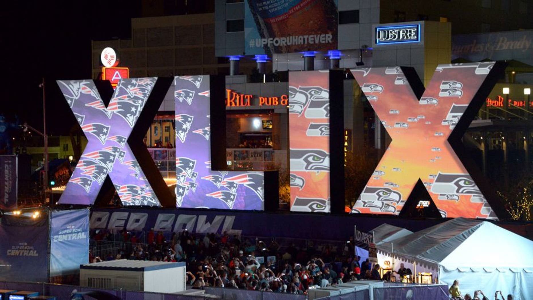 Jan 28, 2015; Phoenix, AZ, USA; General view of the Super Bowl XLIX roman numerals with the logos of the Seattle Seahawks and the New England Patriots at Super Bowl Central. Mandatory Credit: Kirby Lee-USA TODAY Sports