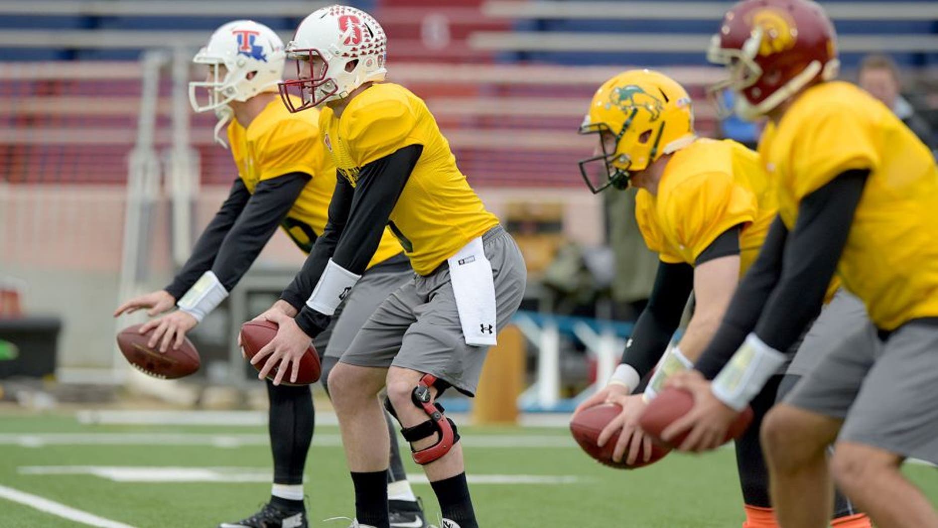 Jan 26, 2016; Mobile, AL, USA; North squad quarterback Jeff Driskel of Louisiana Tech (far left) and quarterback Kevin Hogan of Stanford (left) and quarterback Carson Wentz of North Dakota State (right) and quarterback Cody Kessler of USC (far right) take snaps during Senior Bowl practice at Ladd-Peebles Stadium. Mandatory Credit: Glenn Andrews-USA TODAY Sports