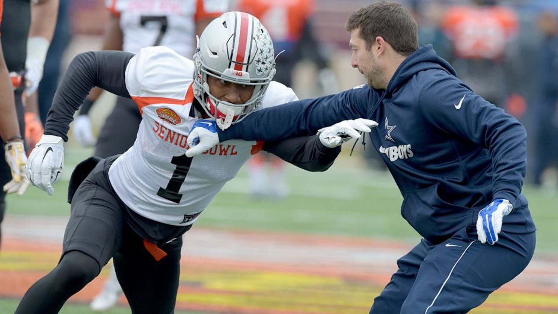 Jan 27, 2016; Mobile, AL, USA; North squad wide receiver Braxton Miller of Ohio State (1) works against a Dallas Cowboys assistant coach on a drill during Senior Bowl practice at Ladd-Peebles Stadium. Mandatory Credit: Glenn Andrews-USA TODAY Sports