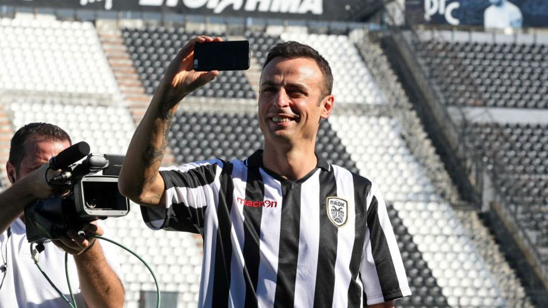 PAOK's new Bulgarian foward Dimitar Berbatov takes a selfie during his presentation at the Toumpa Stadium in Thessaloniki on September 3, 2015. Berbatov has signed to play for one season with PAOK, the Greek Super League club announced on September 3, 2015. AFP PHOTO / SAKIS MITROLIDIS (Photo credit should read SAKIS MITROLIDIS/AFP/Getty Images)