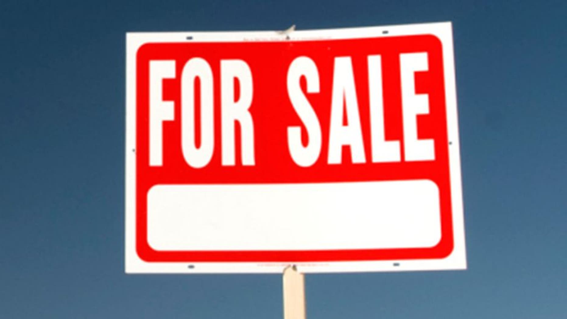 For sale sign in barren landscape.