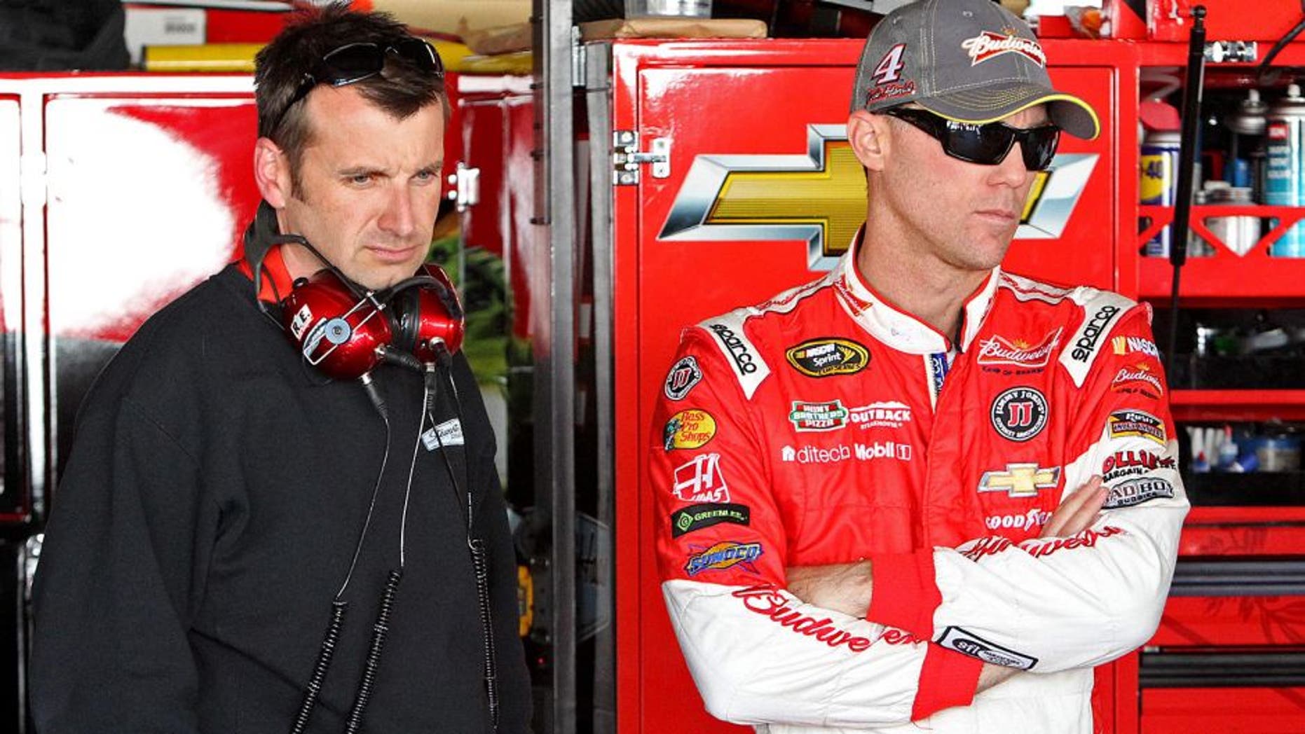 Sep 26, 2014; Dover, DE, USA; NASCAR Sprint Cup driver Kevin Harvick and NASCAR Sprint Cup Series crew chief Rodney Childers stand in the garage during practice for the AAA 400 at Dover International Speedway. Mandatory Credit: Matthew O'Haren-USA TODAY Sports