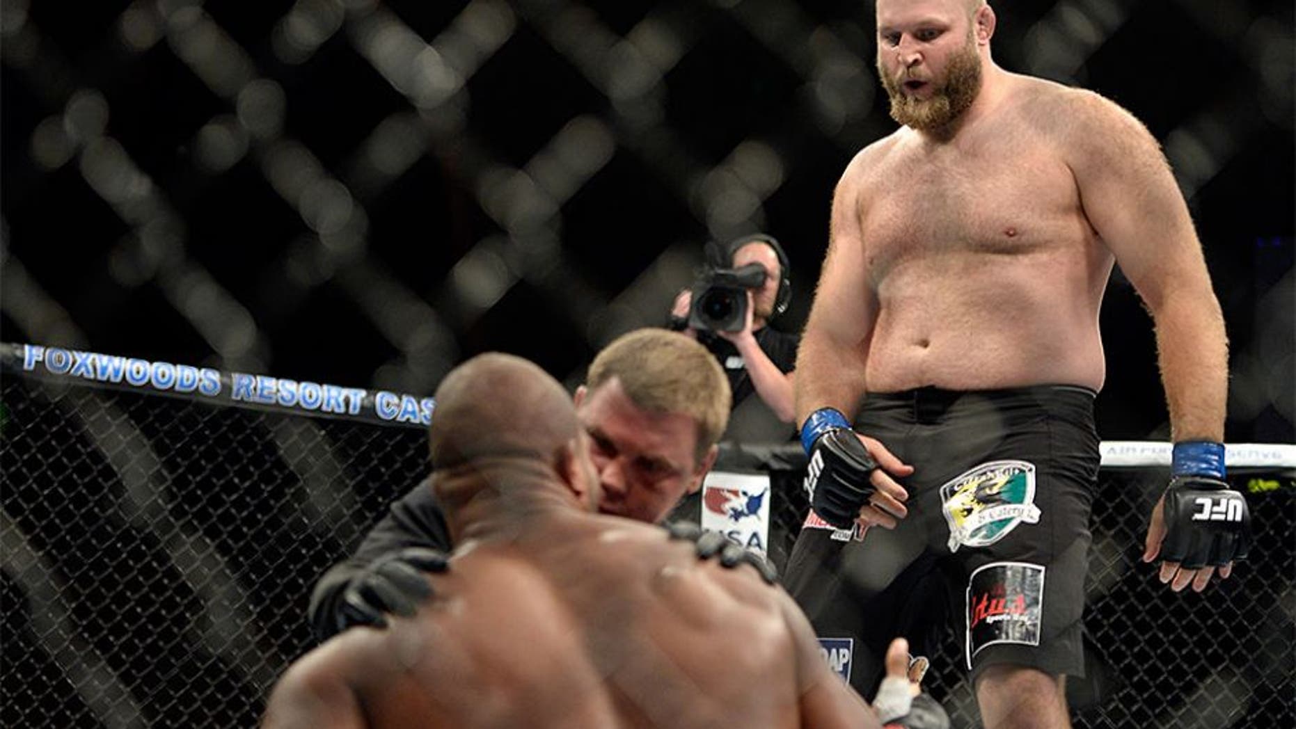 MASHANTUCKET, CT - SEPTEMBER 5: (R-L) Ben Rothwell dances over Alistair Overeem after defeating Overeem in their heavyweight weight fight during the UFC Fight Night event inside the Grand Theatre at Foxwoods Resort Casino on September 5, 2014 in Mashantucket, Connecticut. (Photo by Jeff Bottari/Zuffa LLC/Zuffa LLC via Getty Images) *** Local Caption ***Alistair Overeem;Ben Rothwell