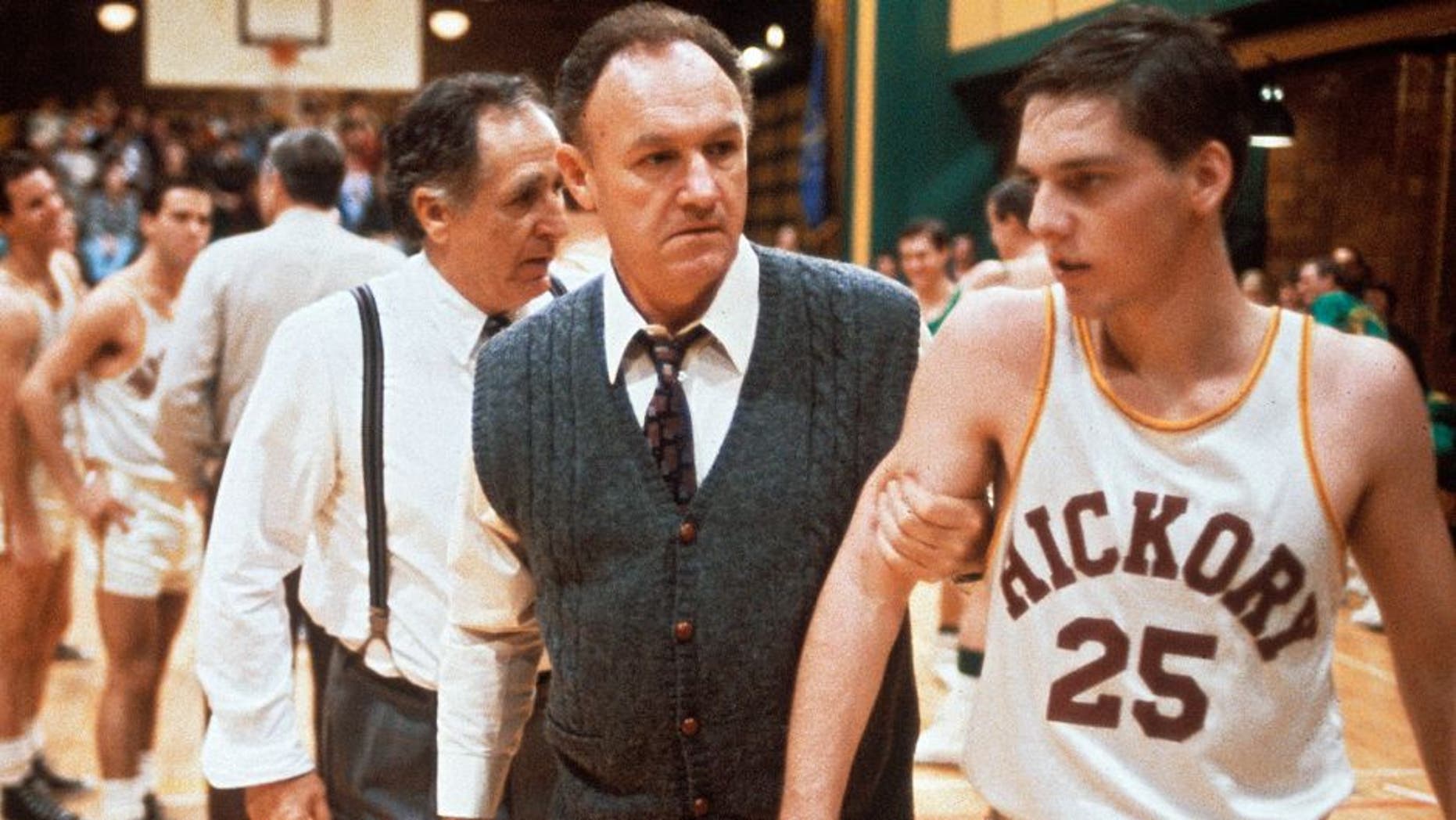 "The coach Norman Dale, played by the American actor Gene Hackman, grasps to the arm of a basketball player before a match and rebukes him, in a scene from the engaging dramatic movie Hoosiers. USA, 1986. (Photo by Mondadori Portfolio via Getty Images)"