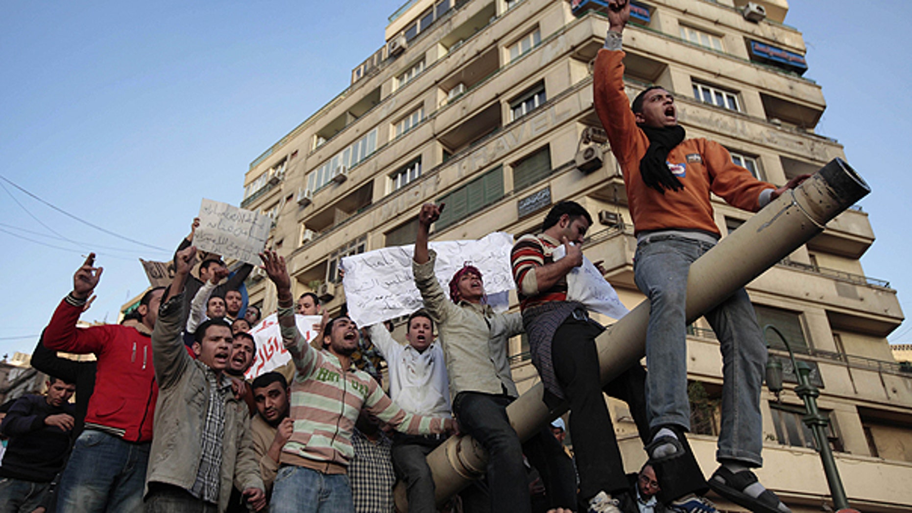 Jan. 29: Egyptian anti-government protesters chant slogans as they stand atop an Egyptian army tank during a protest in Tahrir square in Cairo, Egypt.