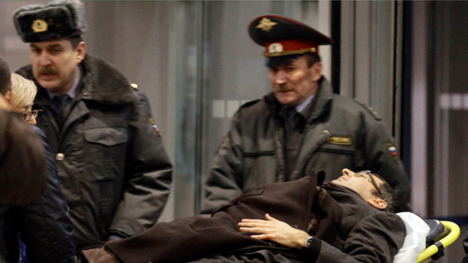 A man wounded in a blast is evacuated from Domodedovo airport in Moscow, Monday, Jan. 24, 2011. An explosion ripped through the international arrivals hall at Moscow's busiest airport on Monday, killing dozens of people and wounding scores, officials said. The Russian president called it a terror attack. (AP Photo/Ivan Sekretarev)