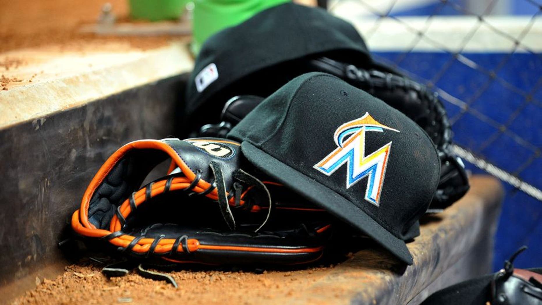March 6, 2012; Miami, FL, USA; Miami Marlins baseball glove and hat are seen in the dugout during a spring training game against the Miami Hurricanes at Marlins Park. Mandatory Credit: Steve Mitchell-USA TODAY Sports