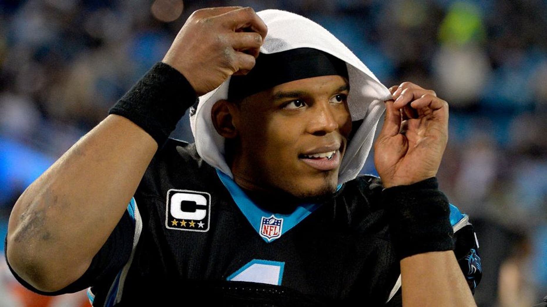 CHARLOTTE, NC - JANUARY 03: Cam Newton #1 of the Carolina Panthers watches from the sideline during the final minute of their game against the Tampa Bay Buccaneers at Bank of America Stadium on January 3, 2016 in Charlotte, North Carolina. The Panthers won 38-10 to clinch home field advantage for the playoffs. (Photo by Grant Halverson/Getty Images)