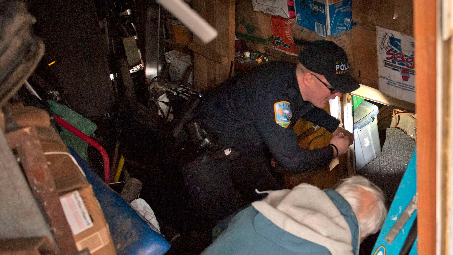 Jan. 28, 2016: Sitka Police Lt. Lance Ewers shines a flashlight at the opening of a tunnel under a trailer in the Vitskari Trailer Park in Sitka, Alaska