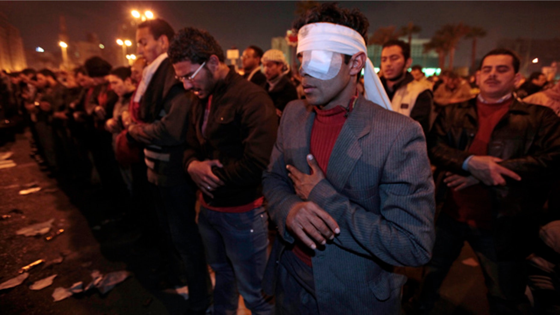 Jan. 30: A protester, who said he was wounded during clashes with police in the previous days, prays with other protesters in Tahrir square in downtown Cairo, Egypt.