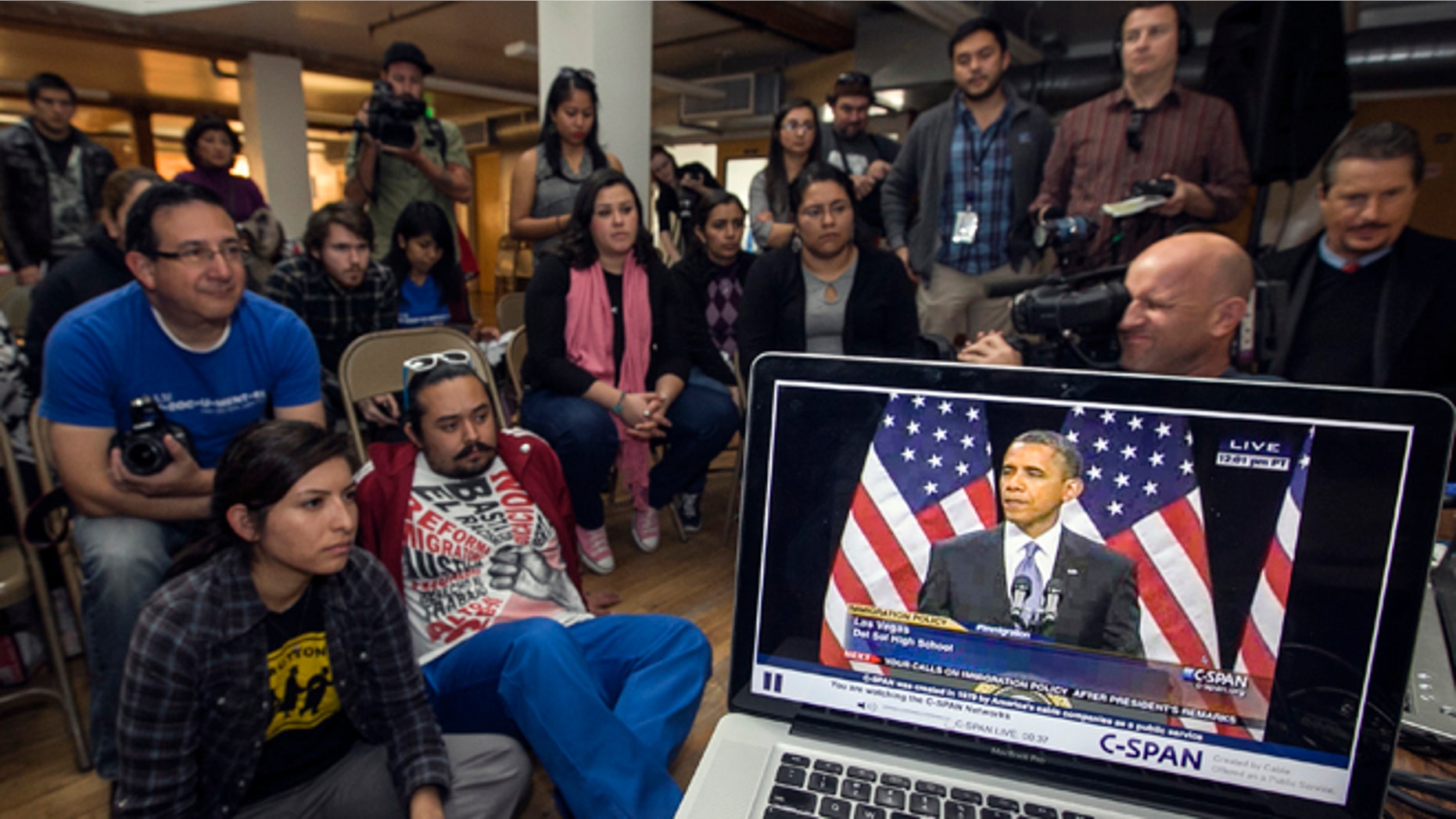 Members of the DREAM Team LA, a Los Angeles immigrants rights group, watch a live video stream of President Obama, Jan. 29, 2013.