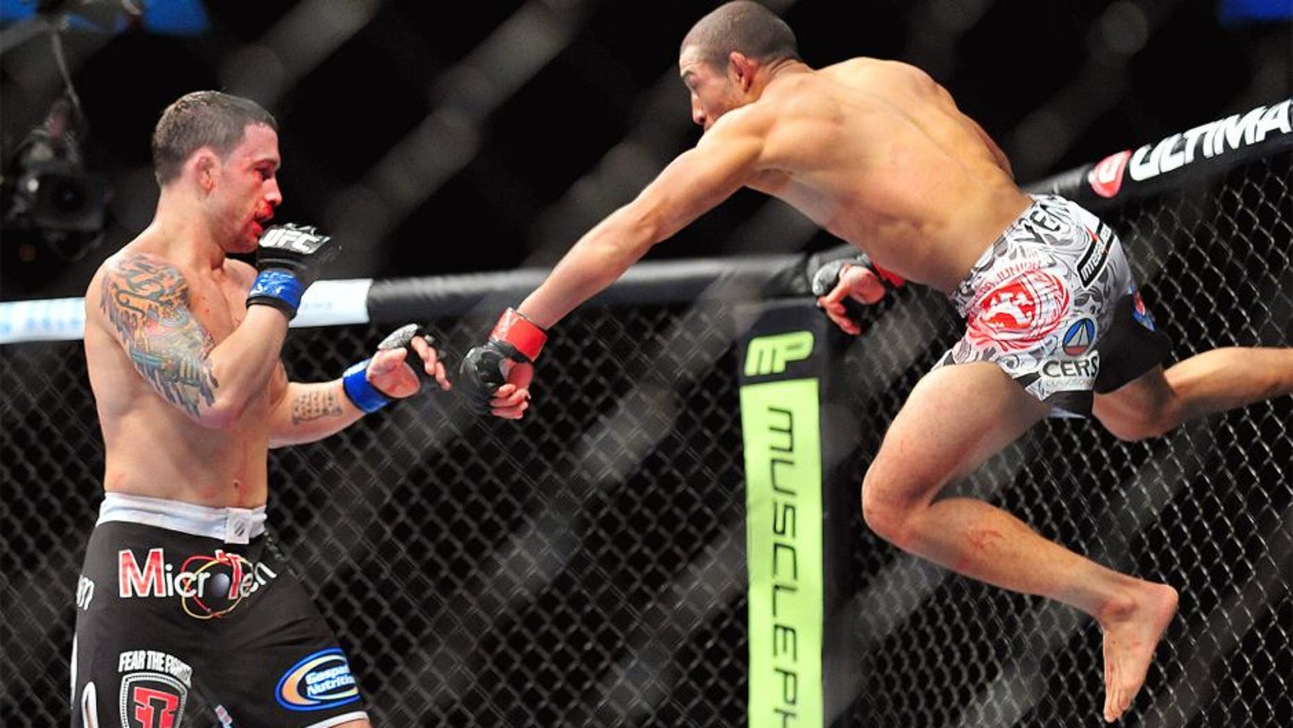 Feb 2, 2013; Las Vegas, NV, USA; Frankie Edgar (left) and Jose Aldo (right) battle each other during UFC 156 at the Mandalay Bay Events Center. Mandatory Credit: Gary A. Vasquez-USA TODAY Sports