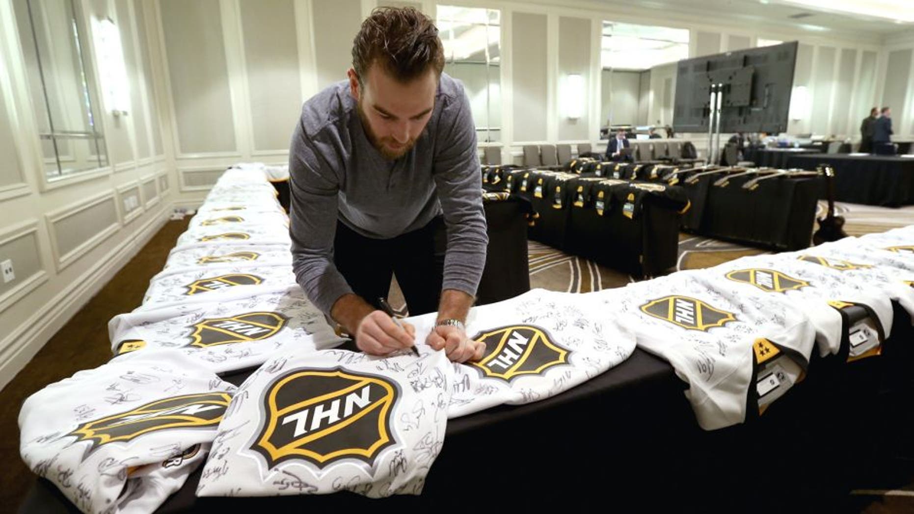 NASHVILLE, TN - JANUARY 29: Goaltender Braden Holtby #70 of the Washington Capitals signs jerseys during the Eastern Conference Skills Competition selection for the 2016 NHL All-Star Game at the Hilton Hotel on January 29, 2016 in Nashville, Tennessee. (Photo by Dave Sandford/NHLI via Getty Images)