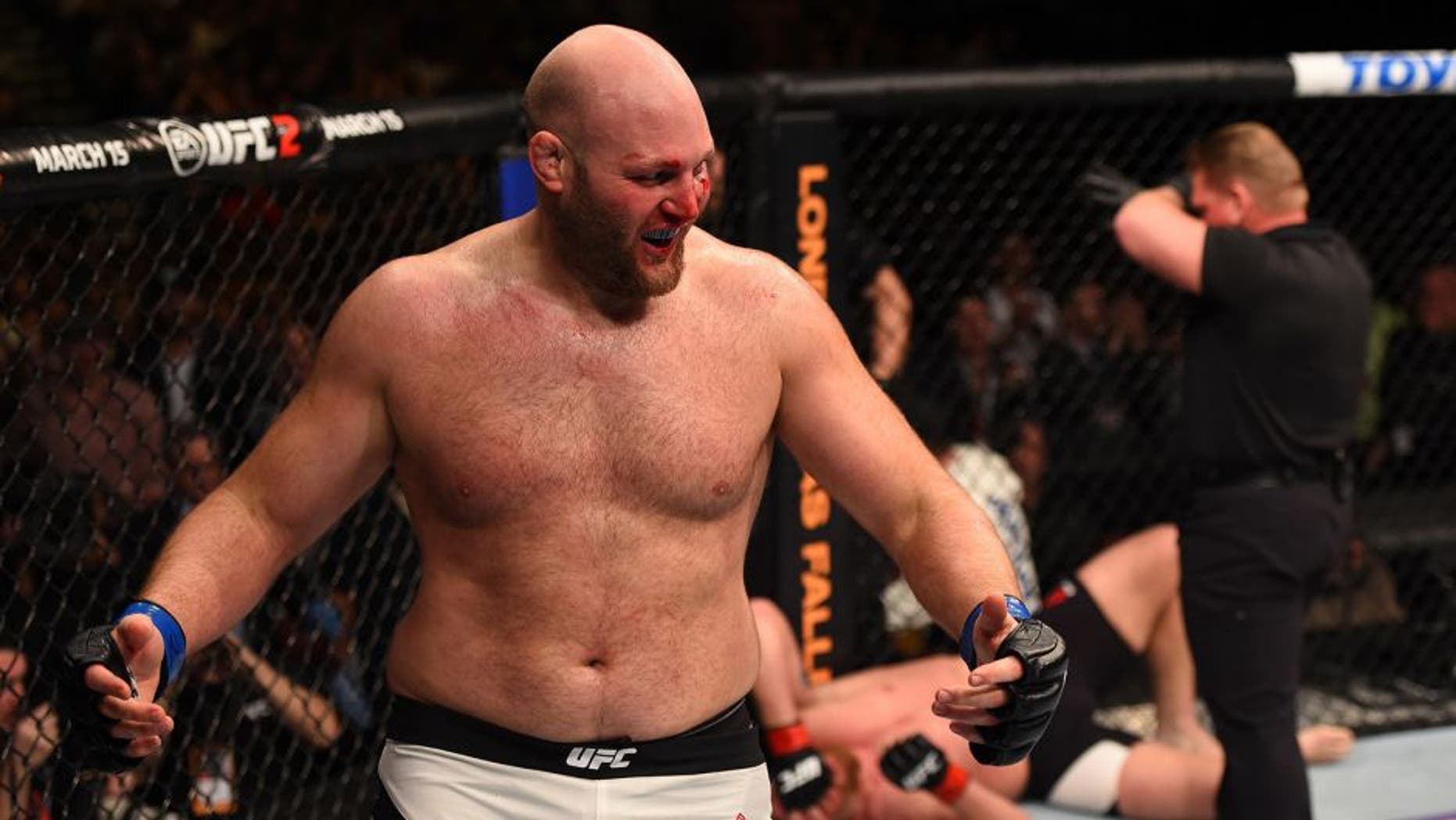 NEWARK, NJ - JANUARY 30: (L-R) Ben Rothwell celebrates his submission victory over Josh Barnett in their heavyweight bout during the UFC Fight Night event at the Prudential Center on January 30, 2016 in Newark, New Jersey. (Photo by Josh Hedges/Zuffa LLC/Zuffa LLC via Getty Images)
