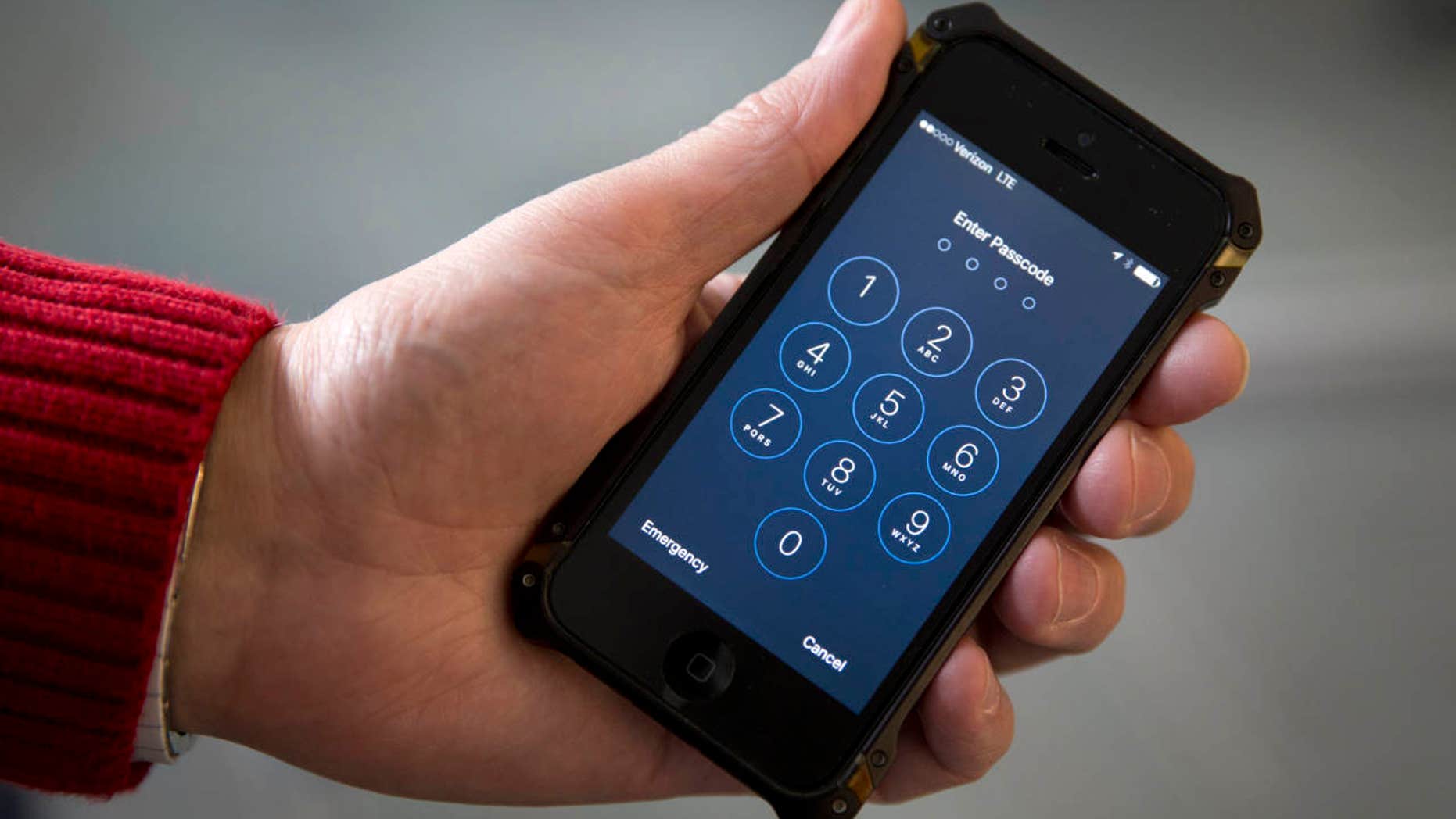 FILE - In this Feb. 17, 2016 file photo an iPhone is seen in Washington. The FBI is defending its decision to withhold information on how it unlocked an iPhone used by one of the San Bernardino, California, shooters.