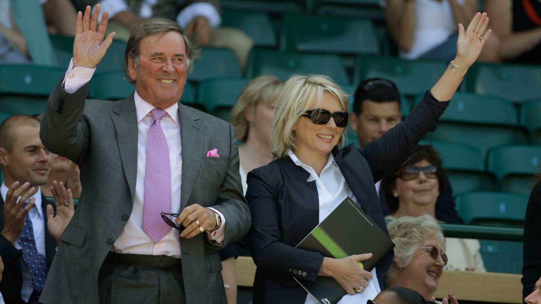 FILE - In this June 28, 2008 file photo, Terry Wogan and Jennifer Saunders are introduced to the crowd from Royal Box on the Centre Court at Wimbledon. Wogan, one of the best-known voices and faces on British television and radio, has died aged 77.