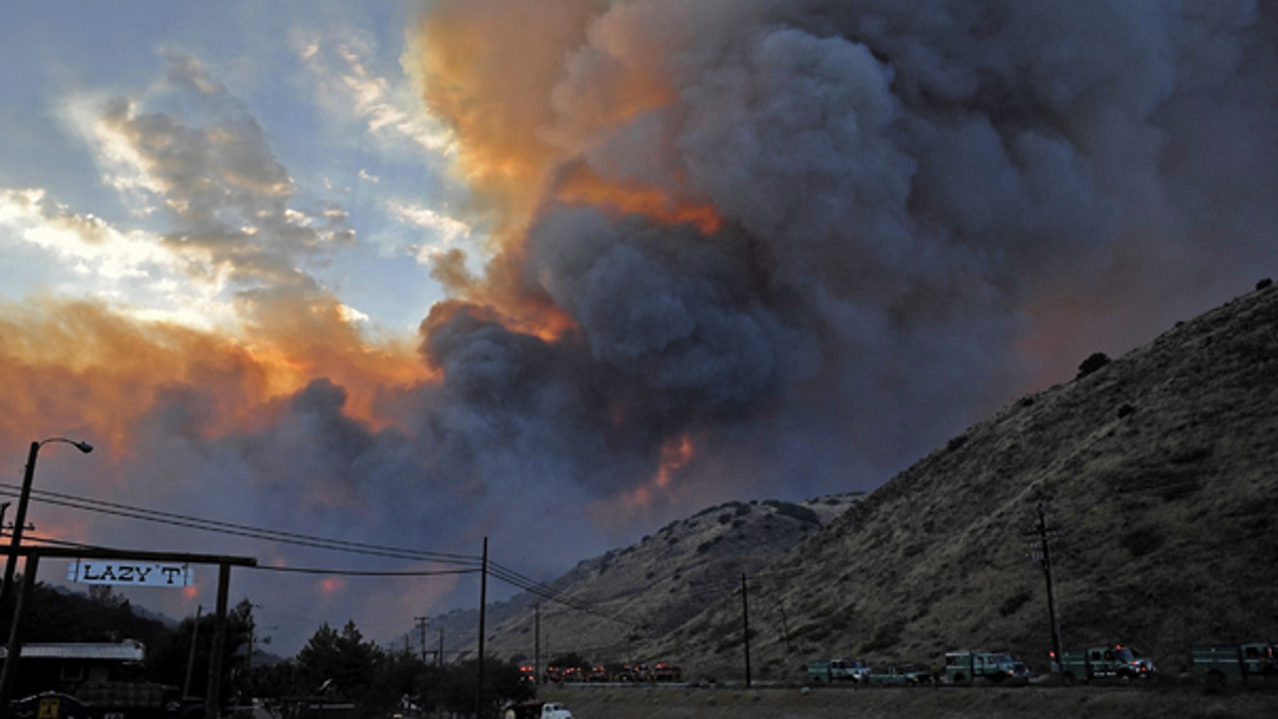 July 29: A fast moving wildfire burns above Elizabeth Lake Road in Leona Valley near Palmdale, Calif. Mandatory evacuations were issued for the community of Leona Valley on Thursday evening, an L.A. County fire inspector said. (AP)
