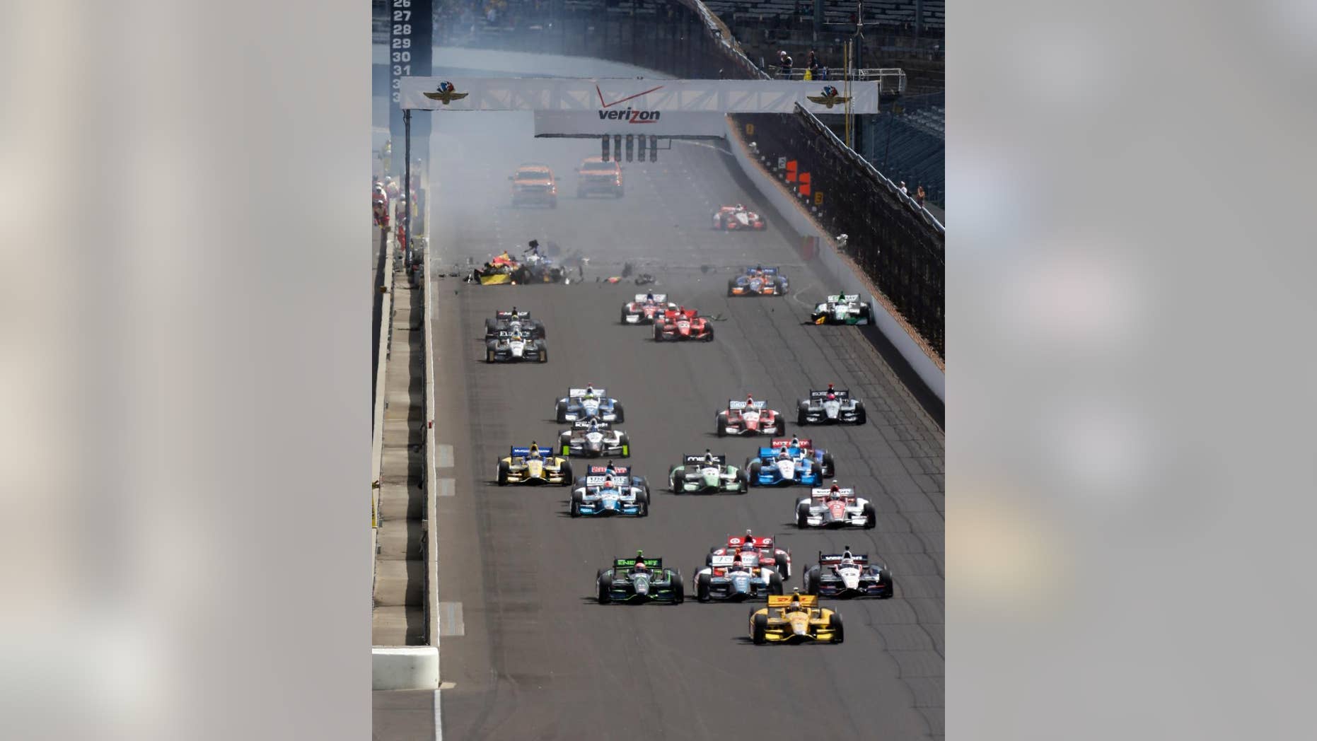 Ryan Hunter-Reay leads a the field at start of the inaugural Grand Prix of Indianapolis IndyCar auto race at the Indianapolis Motor Speedway in Indianapolis, Saturday, May 10, 2014. Sebastian Saavedra, of Colombia, Mikhail Aleshin, of Russia, and Carlos Munoz, of Bogota, were all involved in an accident at the start of the race.(AP Photo/Darron Cummings)