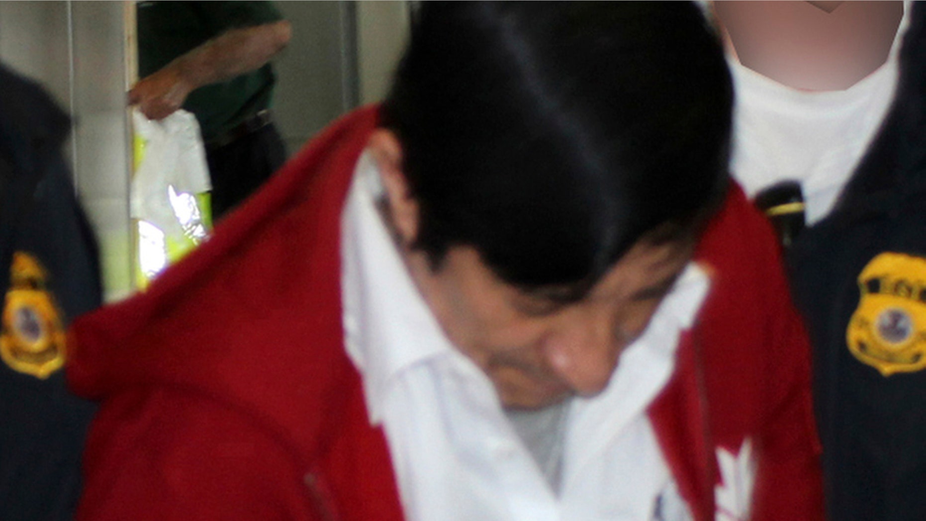 Jorge Sosa, a former Guatemalan soldier, as he is extradited to Los Angeles from Canada on Sept. 21, 2012.