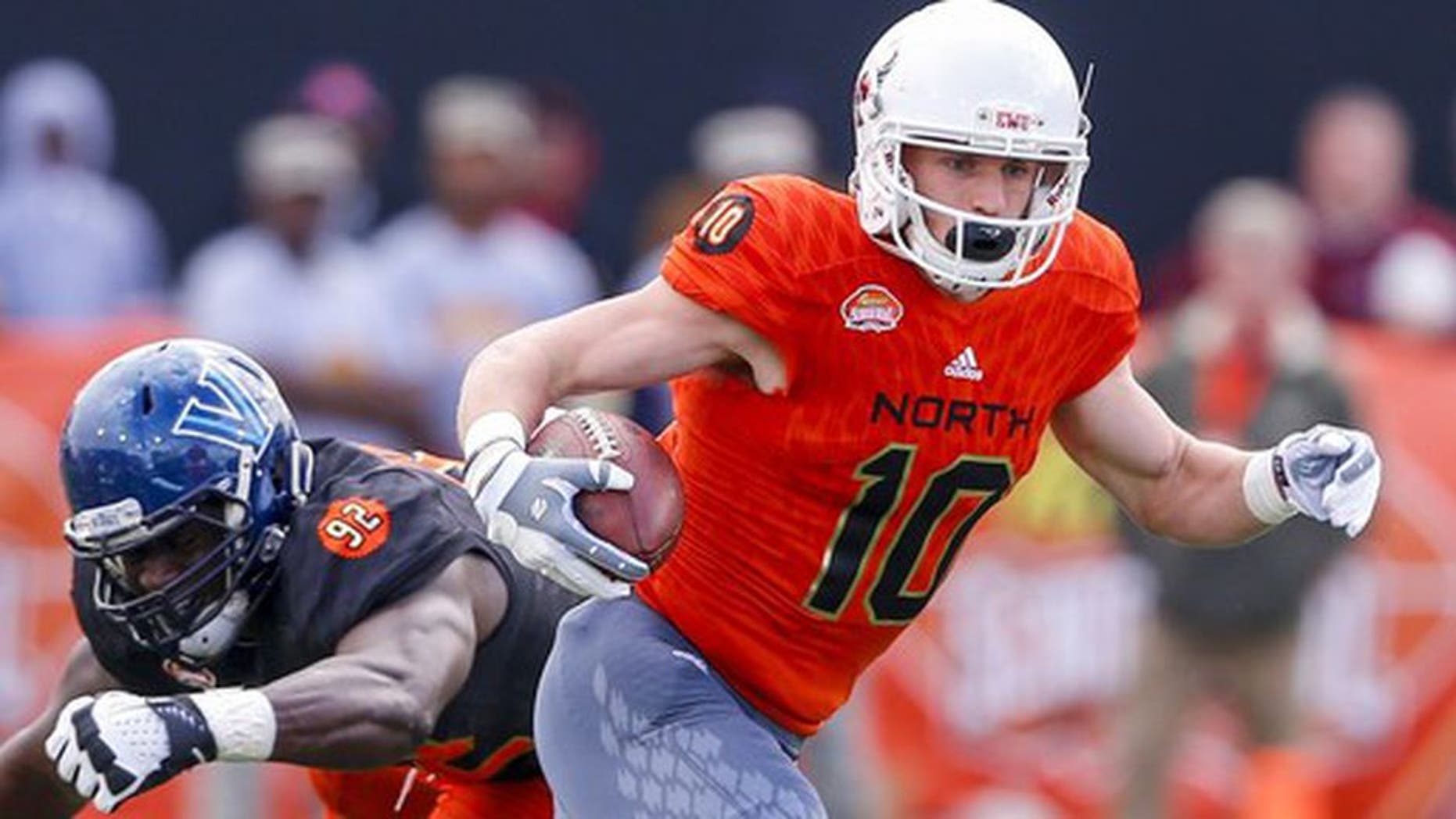 North squad wide receiver Cooper Kupp of Eastern Washington (10) carries the ball as he gets around South squad defensive end Tanoh Kpassagnon of Villanova (92) during the first half of the Senior Bowl NCAA college football game, Saturday, Jan. 28, 2017, at Ladd-Peebles Stadium in Mobile, Ala. (AP Photo/Butch Dill)