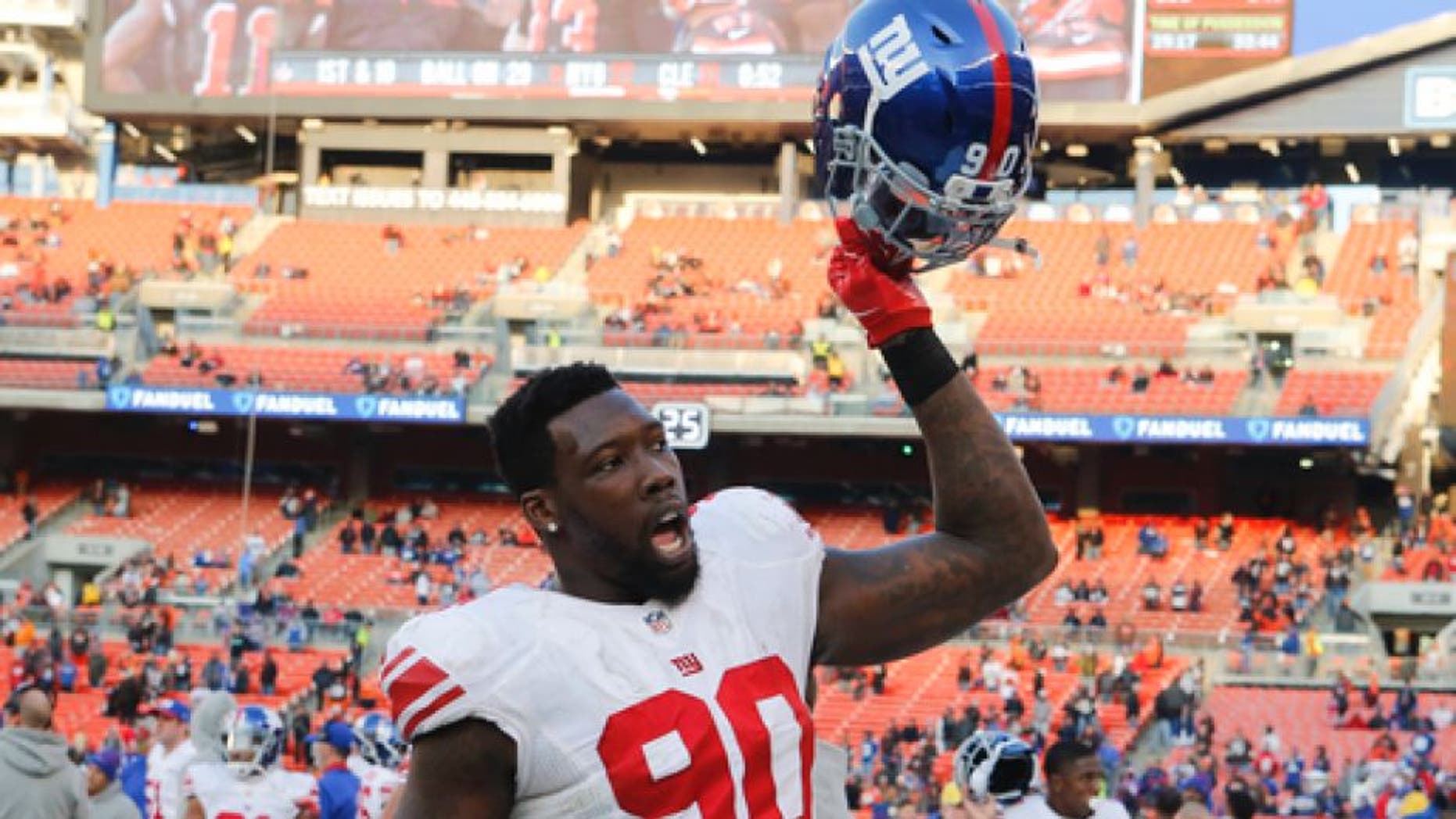 This Nov. 27, 2016 photo shows New York Giants defensive end Jason Pierre-Paul reacting after an NFL football game against the Cleveland Browns in Cleveland. A person with knowledge of the details says the New York Giants have told defensive end Pierre-Paul that he will be made a franchise player. (AP Photo/Ron Schwane)