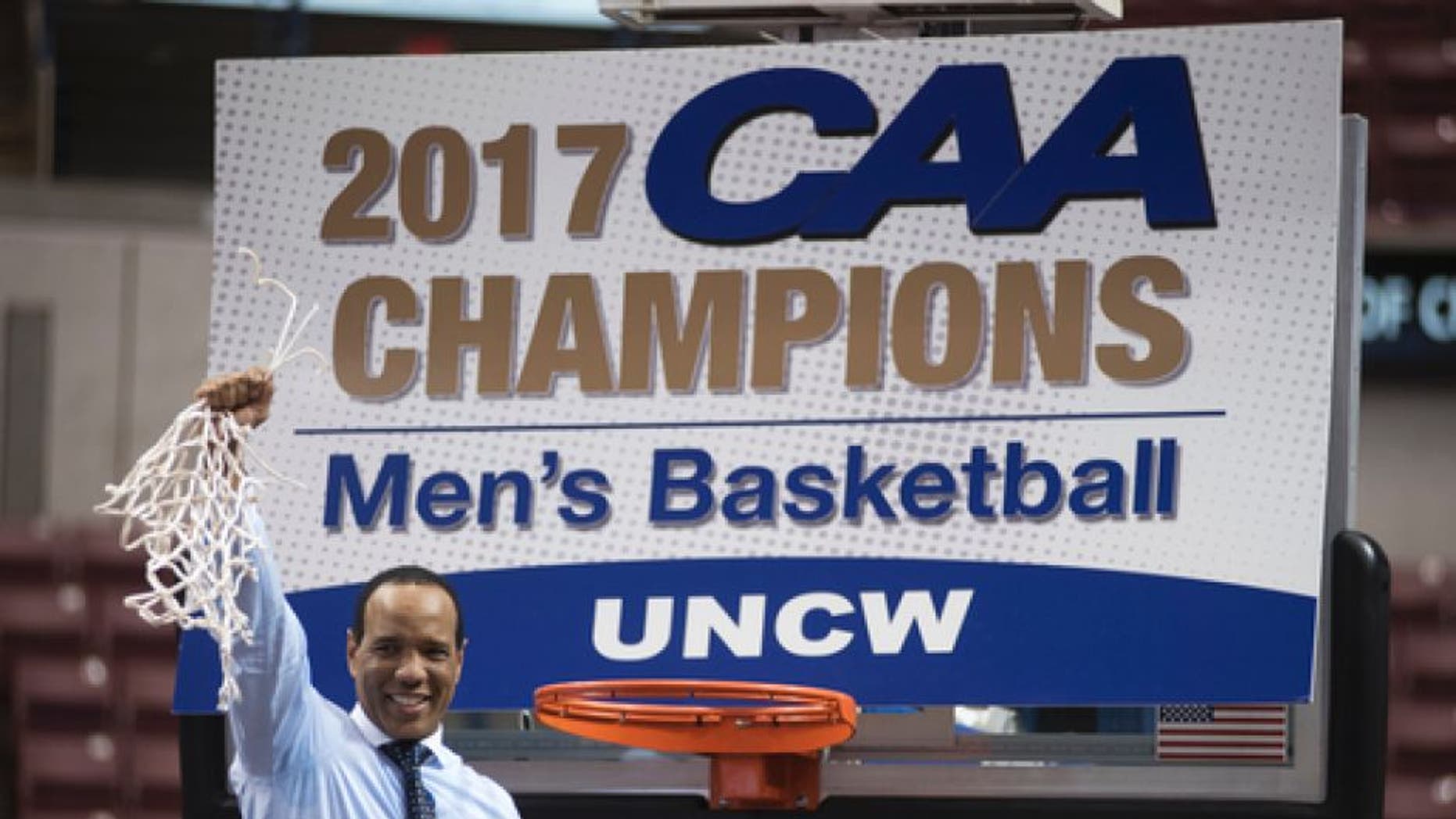 UNCW head coach Kevin Keatts cuts down the net after defeating College of Charleston 78-69 in an NCAA college basketball game in Charleston, S.C., Monday, March 6, 2017. (AP Photo/Mike Spencer)