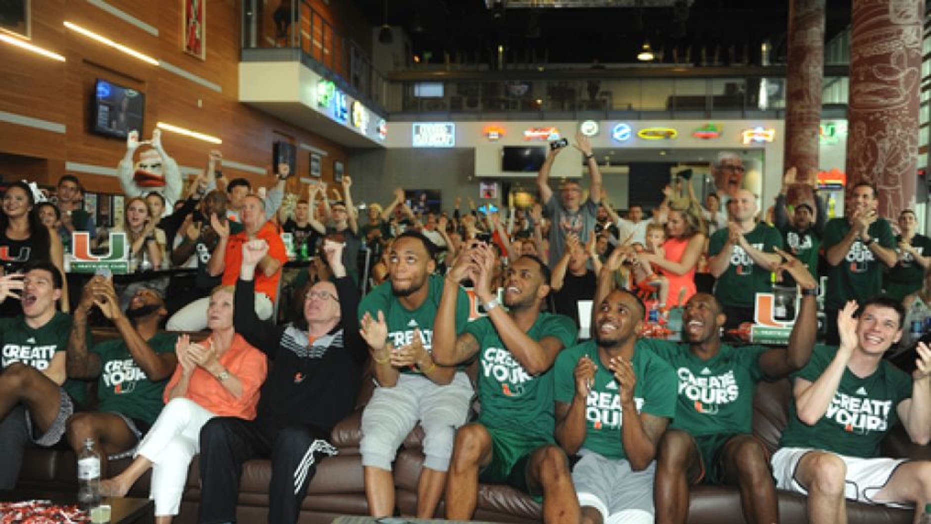 Miami basketball team members react while watching the NCAA men's basketball tournament selection show, Sunday, March 12, 2017, in Coral Gables, Fla The team plays Michigan State in Tulsa. (Joe Cavaretta/South Florida Sun-Sentinel via AP)