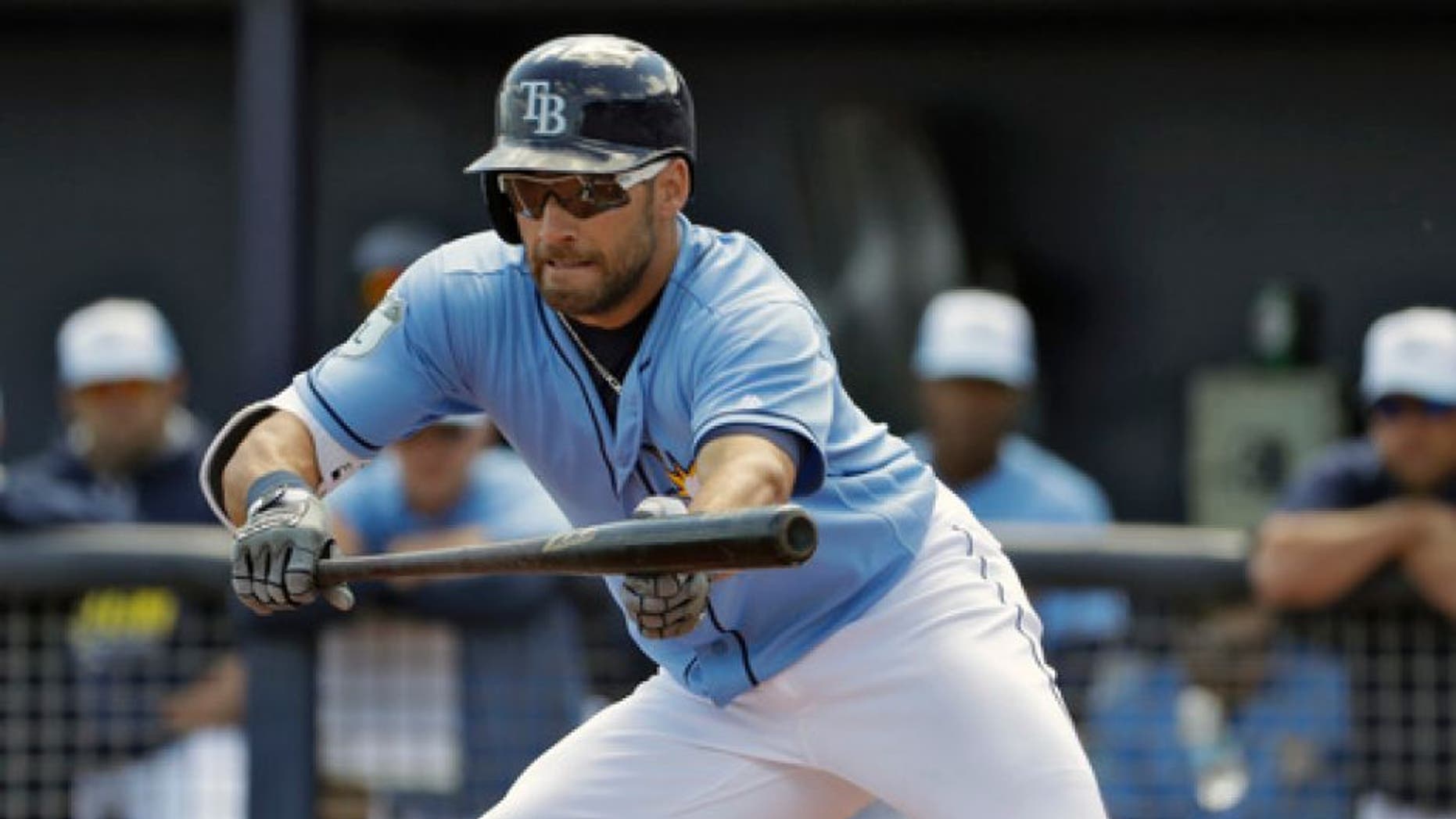 Tampa Bay Rays' Kevin Kiermaier drops down a bunt on a pitch from Boston Red Sox's Kyle Kendrick during the first inning of a spring training baseball game Wednesday, March 15, 2017, in Port Charlotte, Fla. The ball rolled foul. (AP Photo/Chris O'Meara)