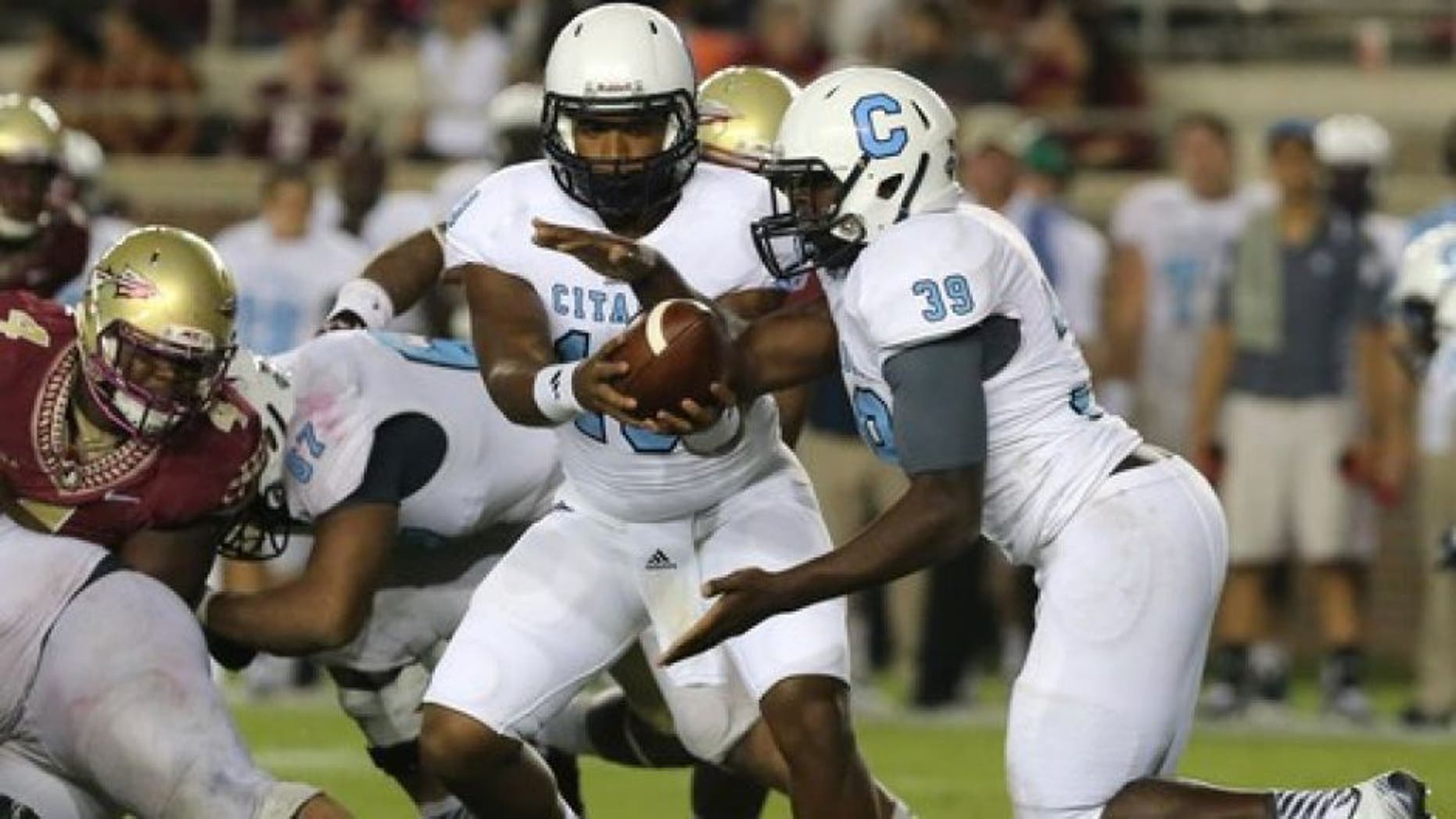 Citadel's Dominique Allen, left, hands off to Isiaha Smith in a play against Florida Sate in an NCAA college football game Saturday, Sept. 6, 2014, in Tallahassee, Fla. Florida State won the game 37-12. (AP Photo/Steve Cannon)