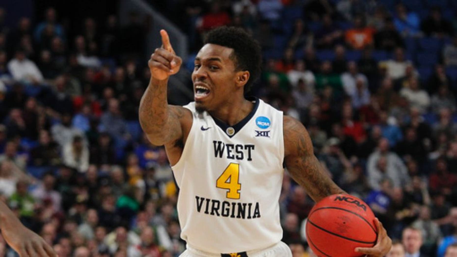 West Virginia guard Dexter Miles Jr. (4) directs his teammates during the second half of a first-round men's college basketball game against Bucknell in the NCAA Tournament, Thursday, March 16, 2017, in Buffalo, N.Y. (AP Photo/Jeffrey T. Barnes)