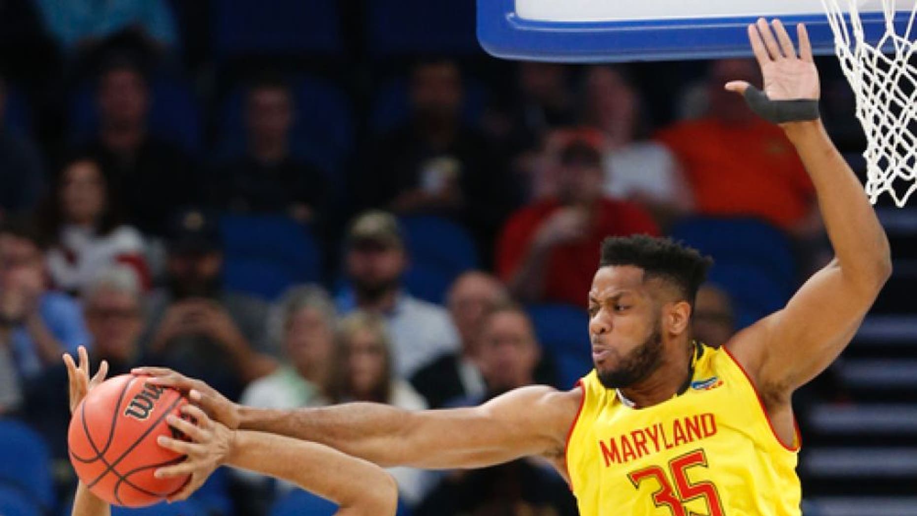 Maryland forward Damonte Dodd (35) blocks a shot from Xavier guard Trevon Bluiett (5) during the first half of the first round of the NCAA college basketball tournament, Thursday, March 16, 2017 in Orlando, Fla. (AP Photo/Wilfredo Lee)