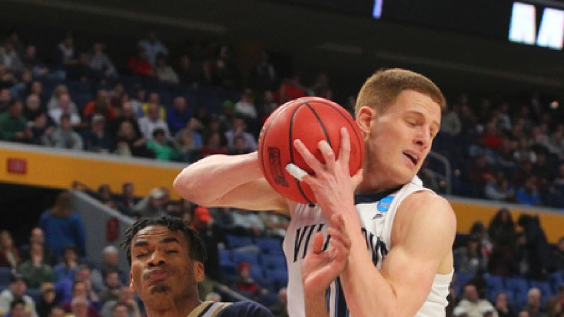 Villanova guard Donte DiVincenzo (10) grabs a rebound against Mount St. Mary's forward Chris Wray (5) during the first half of a first-round men's college basketball game in the NCAA Tournament, Thursday, March 16, 2017, in Buffalo, N.Y. (AP Photo/Bill Wippert)