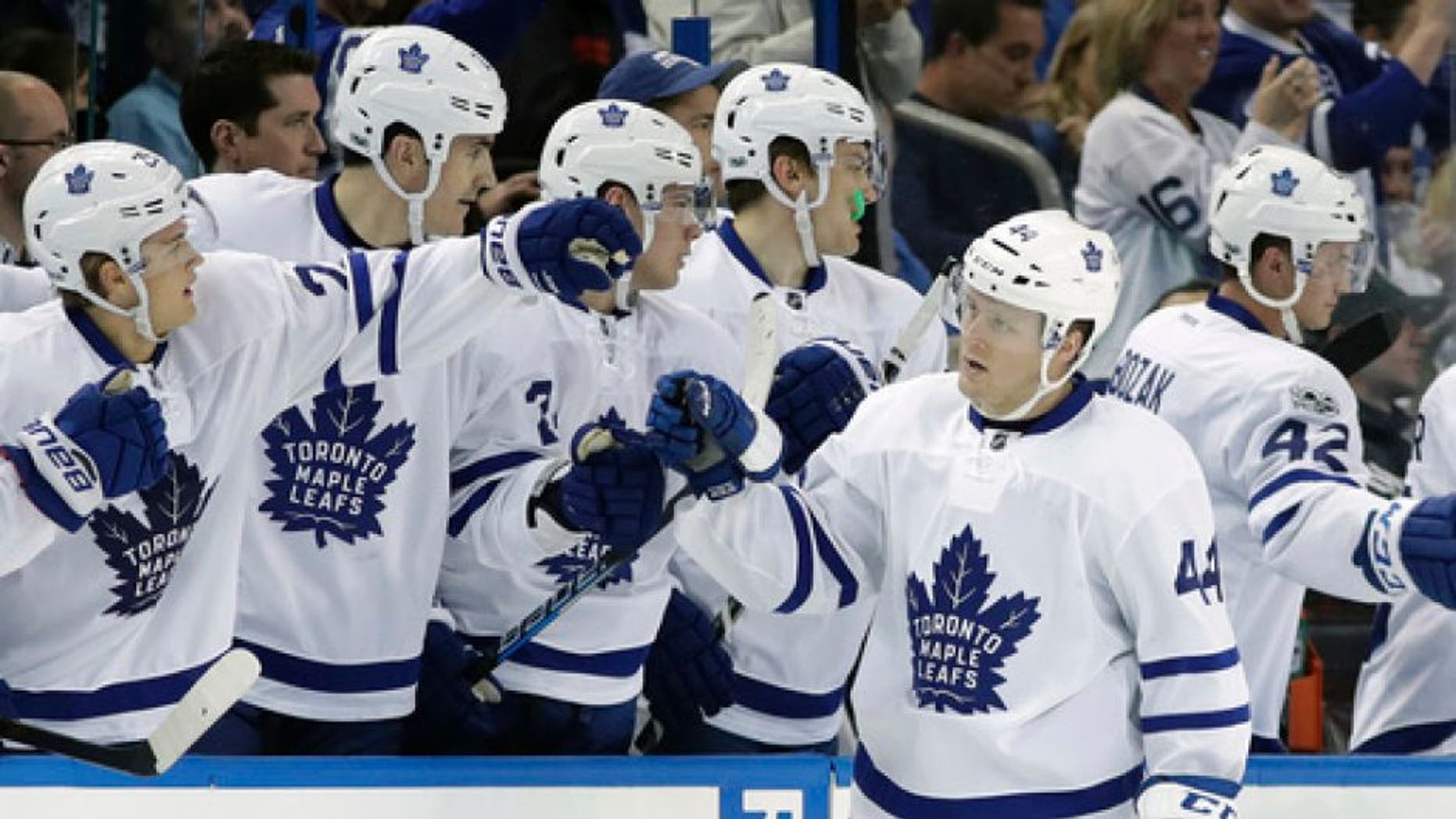Toronto Maple Leafs defenseman Morgan Rielly (44) celebrates with the bench after scoring against the Tampa Bay Lightning during the second period of an NHL hockey game Thursday, March 16, 2017, in Tampa, Fla. (AP Photo/Chris O'Meara)