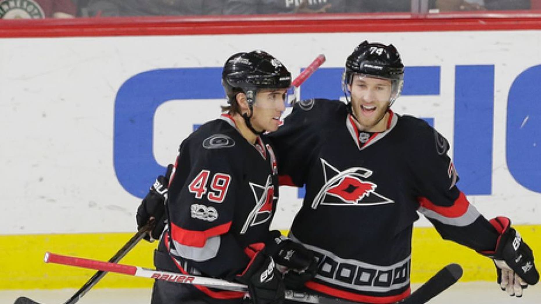 Carolina Hurricanes' Victor Rask (49), of Sweden, is congratulated by Jaccob Slavin (74) following Rask's game-winning goal against the Minnesota Wild during the third period of an NHL hockey game in Raleigh, N.C., Thursday, March 16, 2017. Carolina won 3-1. (AP Photo/Gerry Broome)