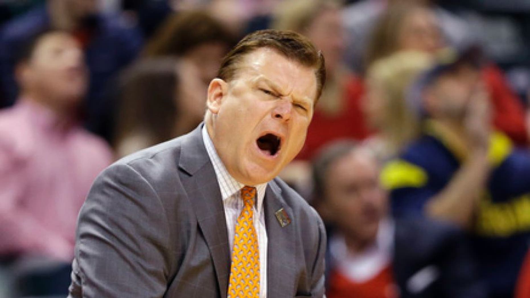 Oklahoma State head coach Brad Underwood yells from the sideline during a first-round game against Michigan in the men's NCAA college basketball tournament in Indianapolis, Friday, March 17, 2017. (AP Photo/Michael Conroy)