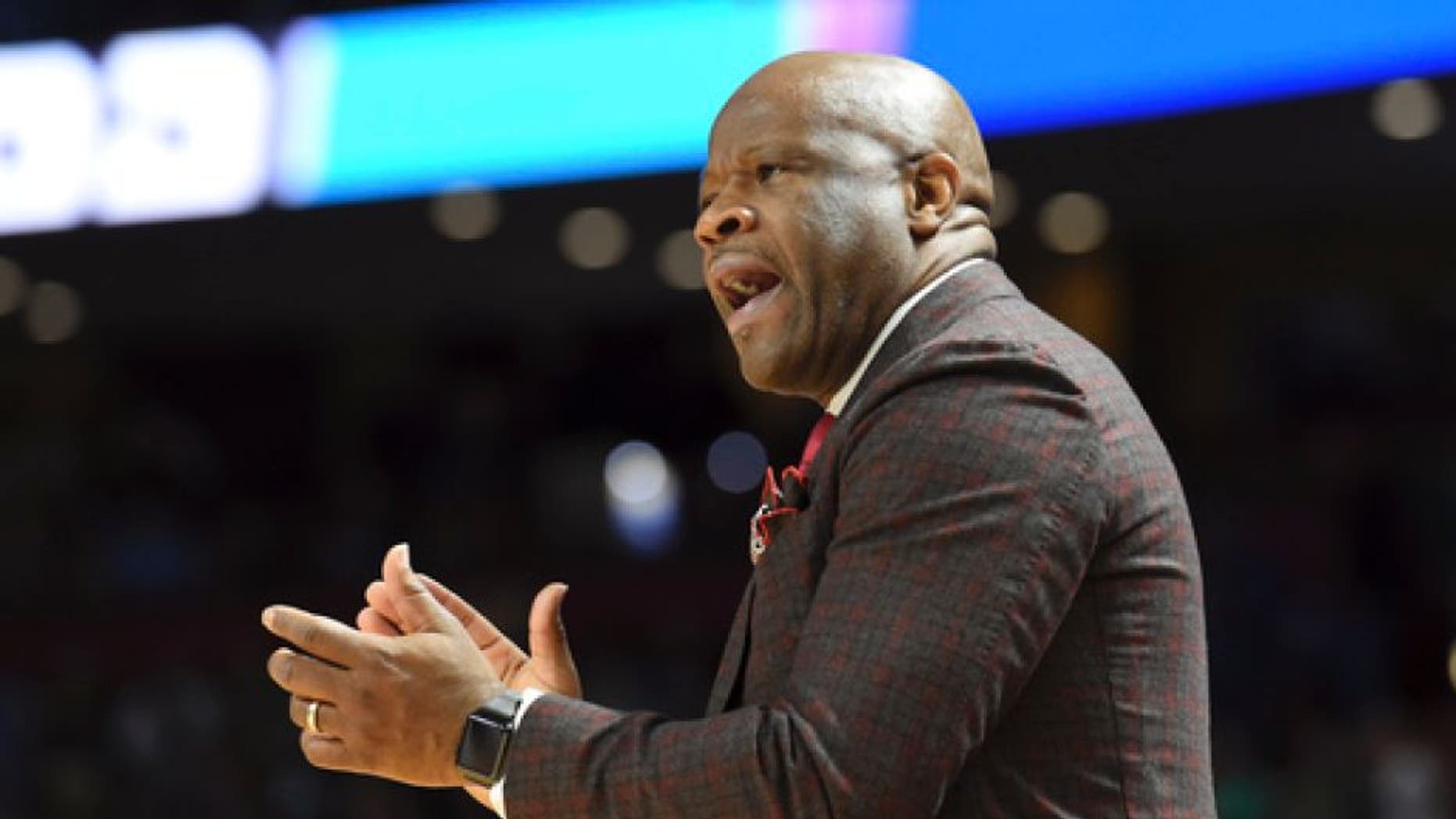 Arkansas head coach Mike Anderson applauds his team against Seton Hall during the first half in a first-round game of the NCAA men's college basketball tournament in Greenville, S.C., Friday, March 17, 2017. (AP Photo/Rainier Ehrhardt)