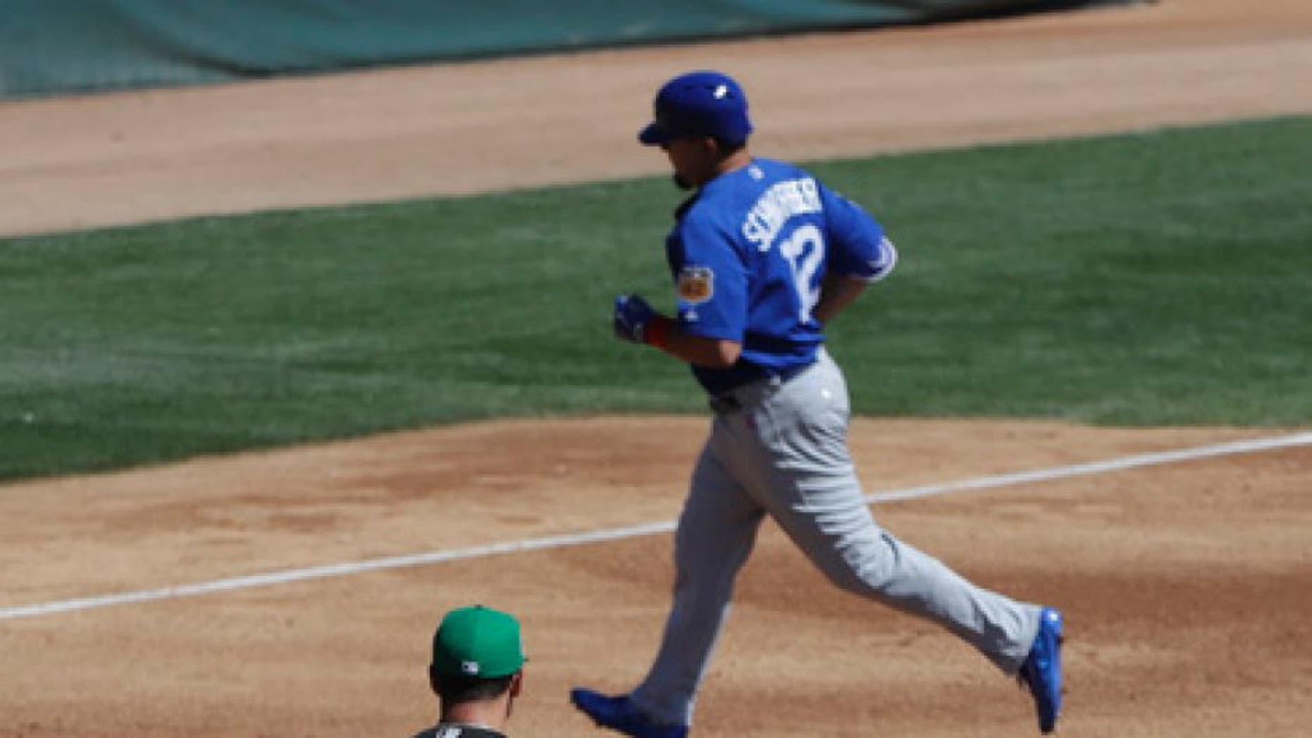 Chicago White Sox's Derek Holland walks back to the mound after giving up a three-run home run to Chicago Cubs' Kyle Schwarber during the third inning of a spring training baseball game Friday, March 17, 2017, in Phoenix. (AP Photo/Darron Cummings)