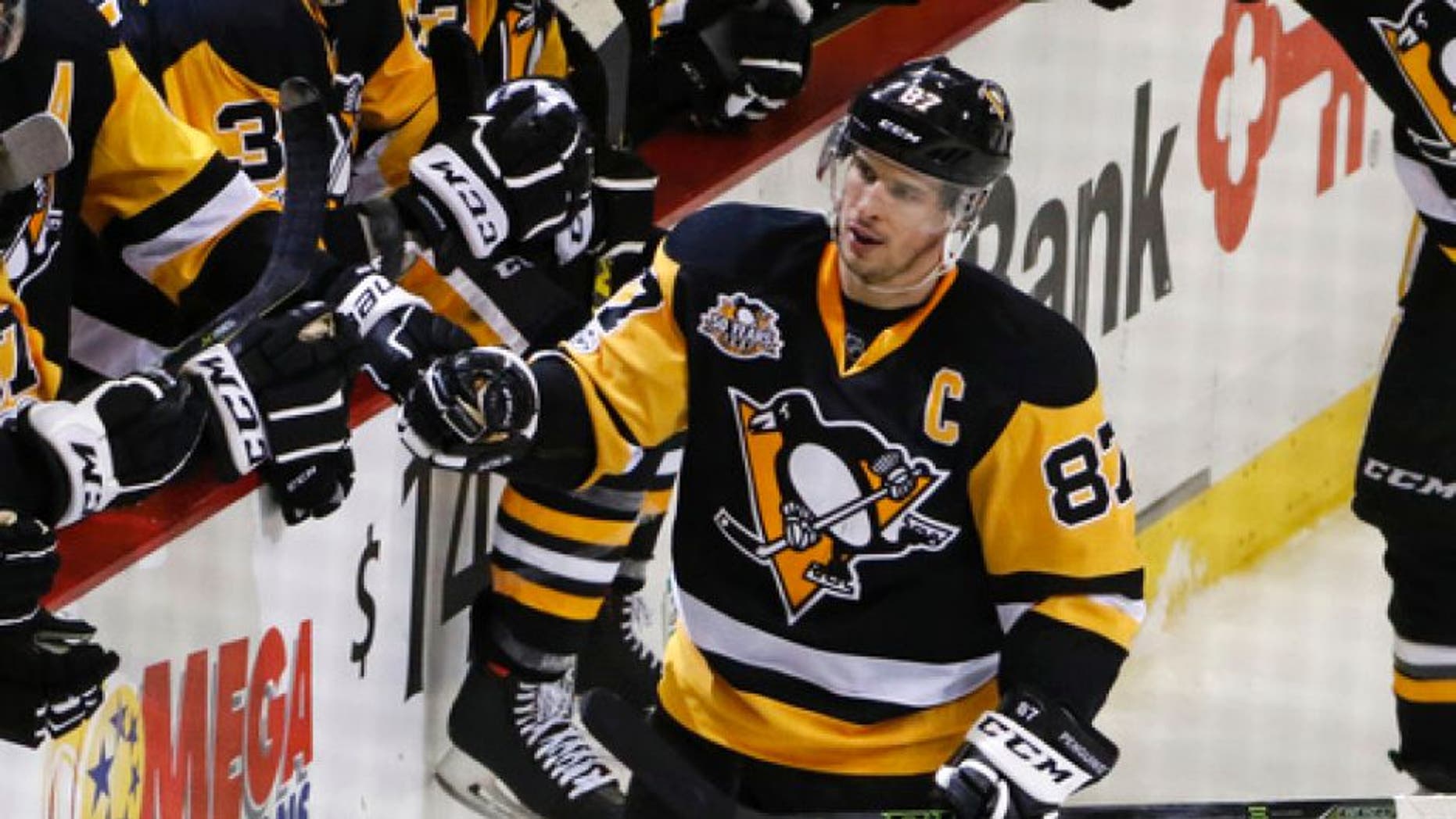 Pittsburgh Penguins' Sidney Crosby (87) celebrates his empty-net goal in the third period of an NHL hockey game against the New Jersey Devils in Pittsburgh, Friday, March 17, 2017. (AP Photo/Gene J. Puskar)