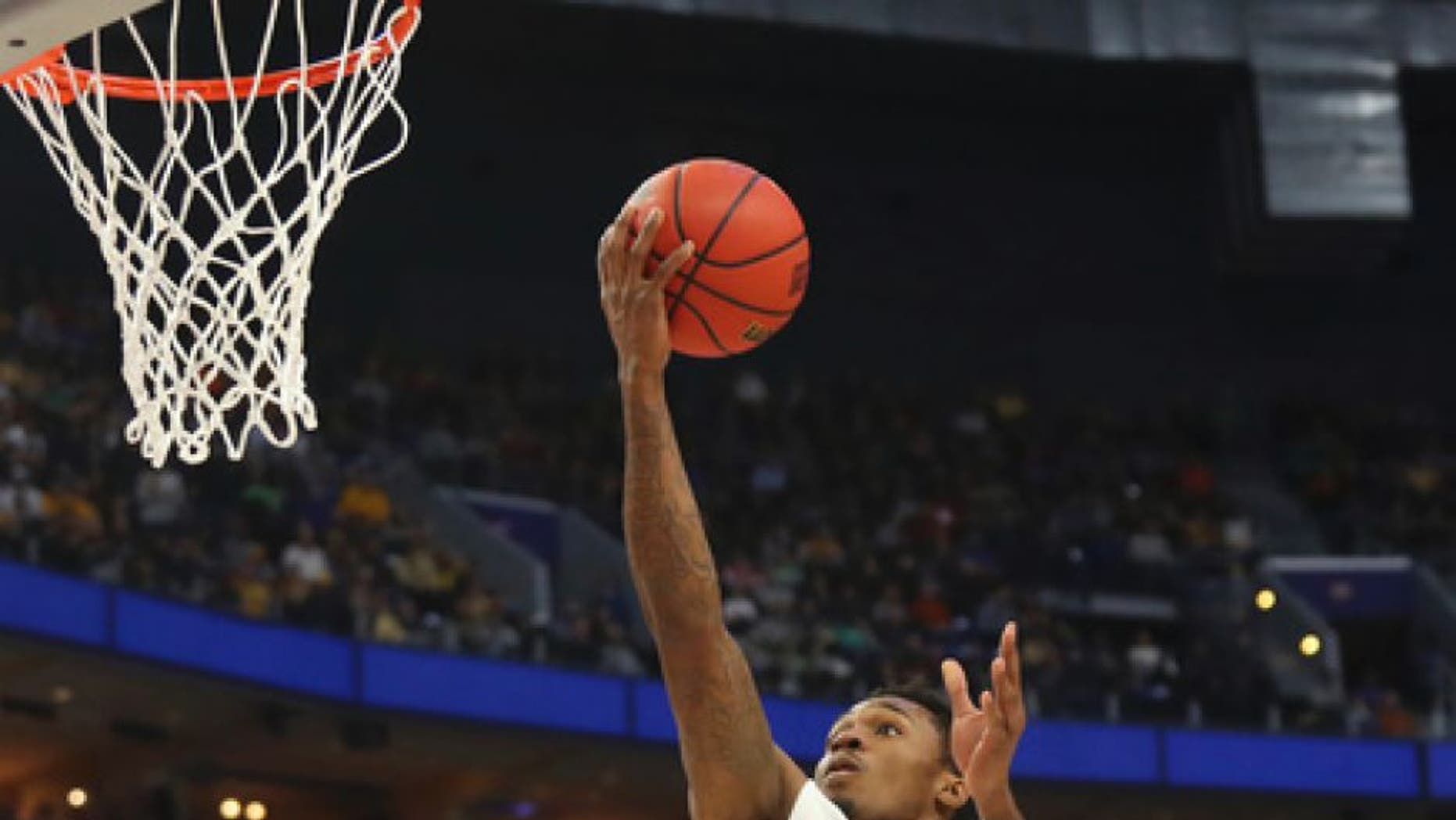 West Virginia guard Daxter Miles Jr. (4) drives to the basket against Notre Dame during the first half of a second-round men's college basketball game in the NCAA Tournament, Saturday, March 18, 2017, in Buffalo, N.Y. (AP Photo/Bill Wippert)
