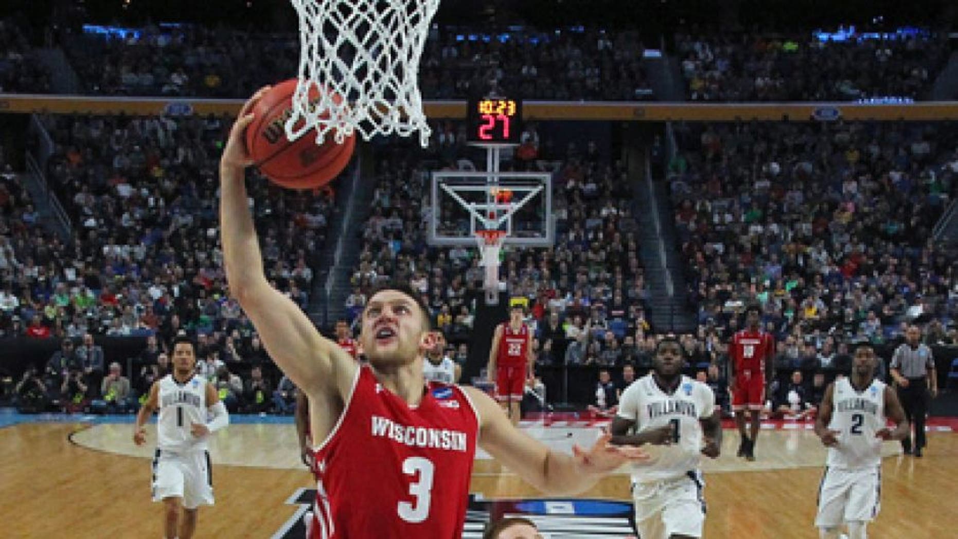 Wisconsin guard Zak Showalter (3) drives to the basket against Villanova guard Donte DiVincenzo (10) during the second half of a second-round game in the NCAA men's college basketball tournament, Saturday, March 18, 2017, in Buffalo, N.Y. Wisconsin won 65-62. (AP Photo/Bill Wippert)