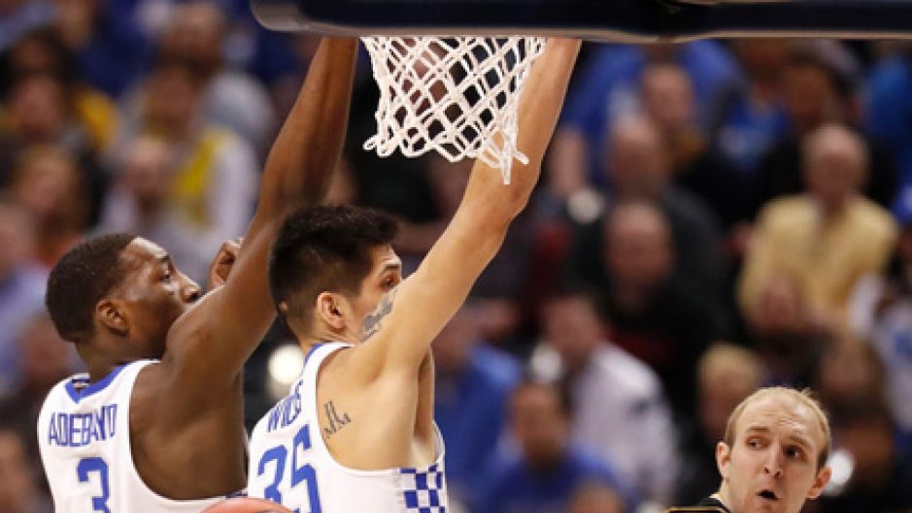 Wichita State's Conner Frankamp, right, passes around Kentucky's Bam Adebayo (3) and Derek Willis (35) during the first half of a second-round game in the men's NCAA college basketball tournament Sunday, March 19, 2017, in Indianapolis. (AP Photo/Jeff Roberson)