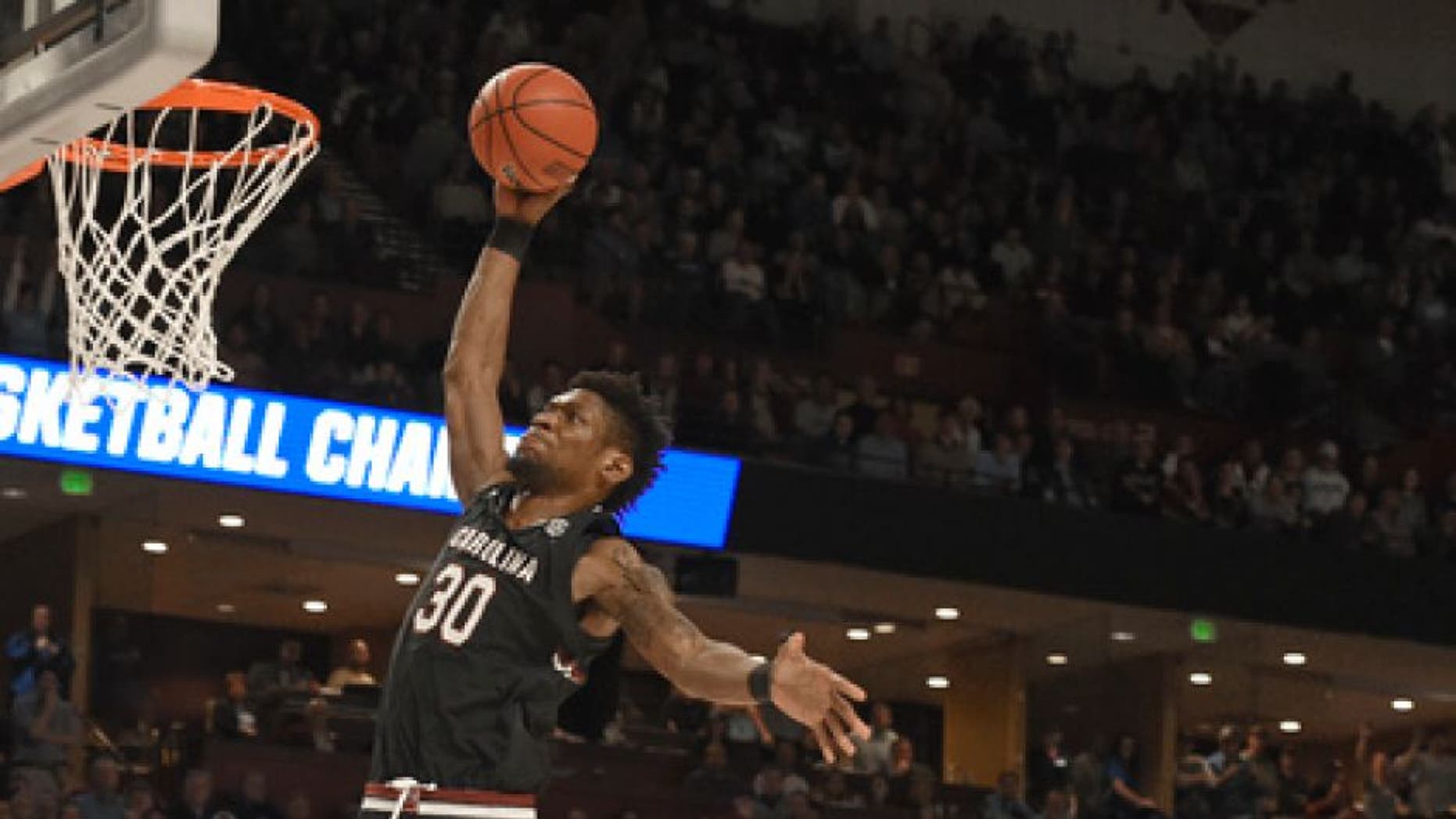 South Carolina's Chris Silva (30) goes up to dunk past Duke's Frank Jackson (15) during the second half in a second-round game of the NCAA men's college basketball tournament in Greenville, S.C., Sunday, March 19, 2017. (AP Photo/Rainier Ehrhardt)