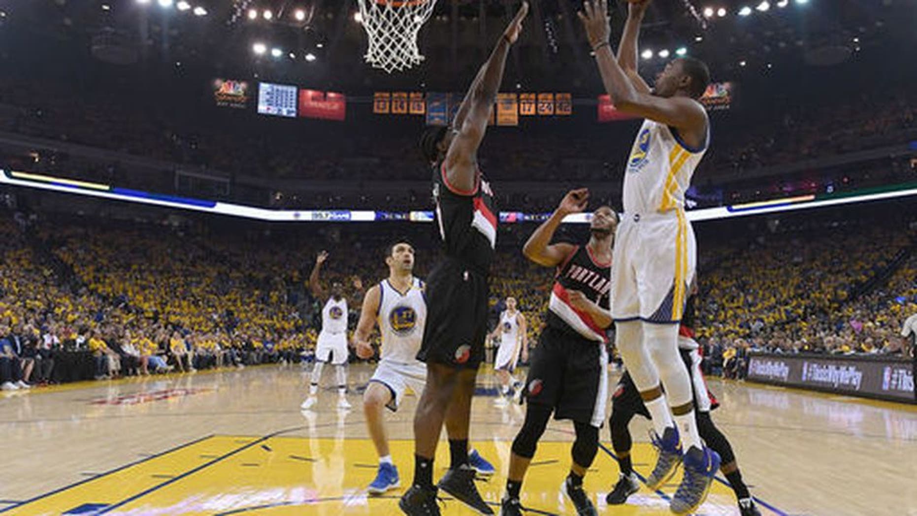 OAKLAND, CA - APRIL 16: Kevin Durant #35 of the Golden State Warriors goes up for a layup over Noah Vonleh #21 of the Portland Trail Blazers in the first quarter during Game One of the first round of the 2017 NBA Playoffs at ORACLE Arena on April 16, 2017 in Oakland, California. NOTE TO USER: User expressly acknowledges and agrees that, by downloading and or using this photograph, User is consenting to the terms and conditions of the Getty Images License Agreement. (Photo by Thearon W. Henderson/Getty Images)