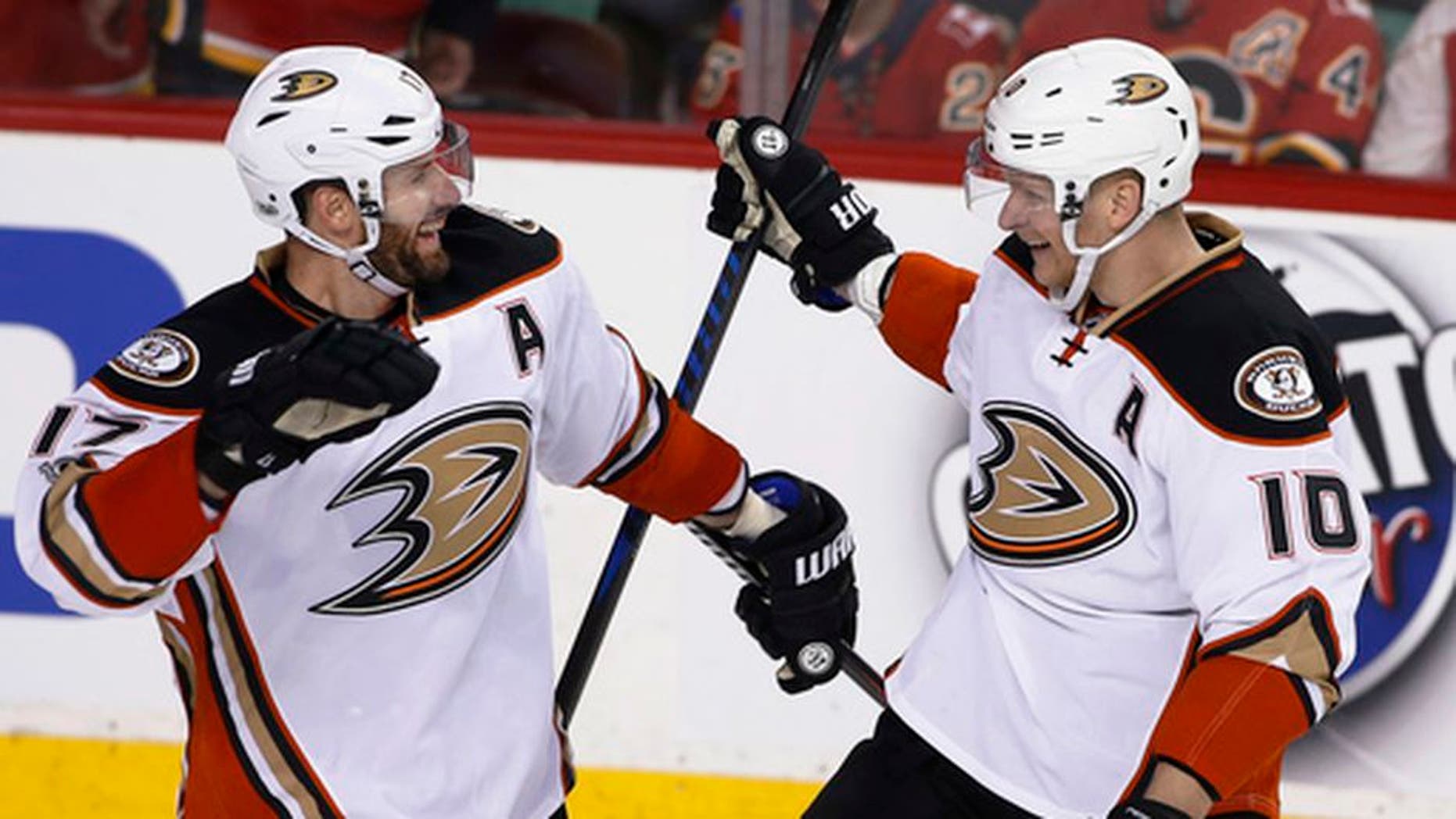 Anaheim Ducks' Corey Perry, right, celebrates his overtime goal against the Calgary Flames with Ryan Kesler during overtime in Game 3 of a first-round NHL hockey Stanley Cup playoff series in Calgary, Alberta, Monday, April 17, 2017. (Larry MacDougal/The Canadian Press via AP)