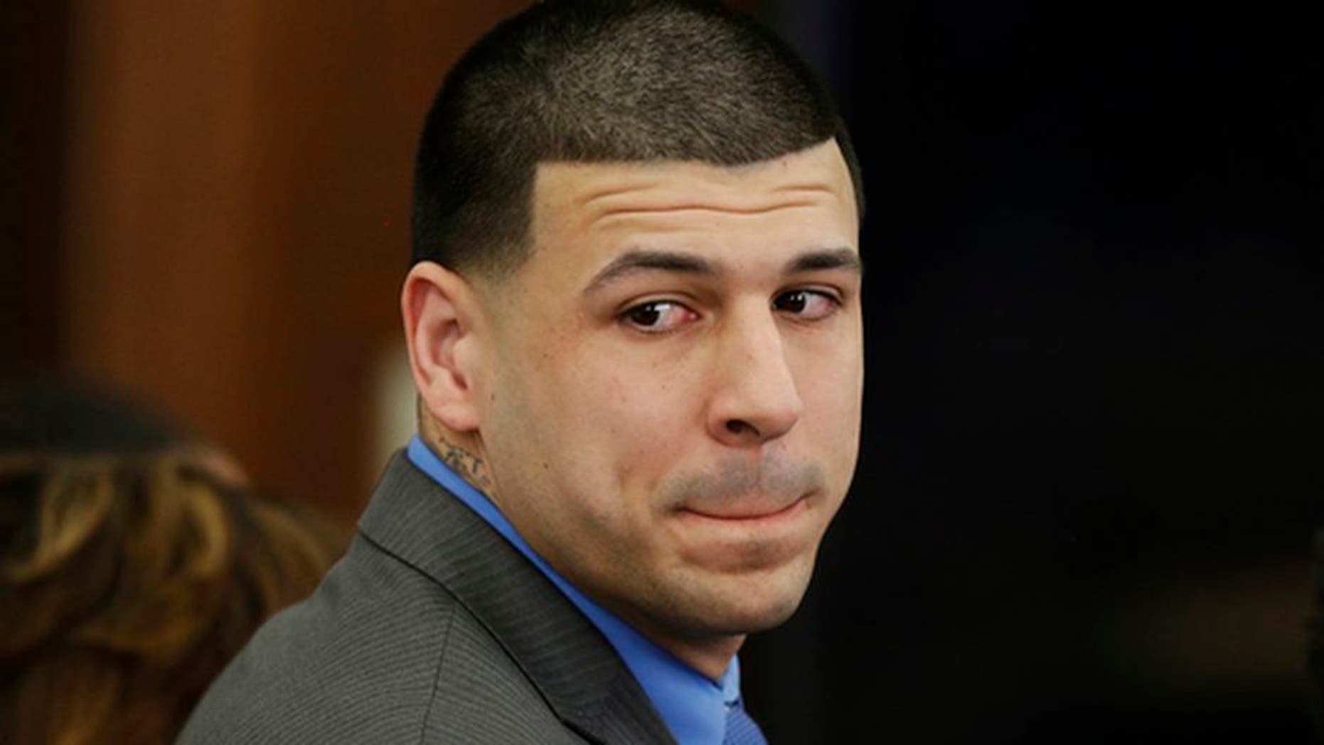 FILE - In this Friday, April 14, 2017, file photo, Former New England Patriots tight end Aaron Hernandez turns to look in the direction of the jury as he reacts to his double murder acquittal at Suffolk Superior Court in Boston. Hernandez hung himself and was pronounced dead at a Massachusetts hospital early Wednesday, April 19, 2017, according to officials. (AP Photo/Stephan Savoia, Pool, File)