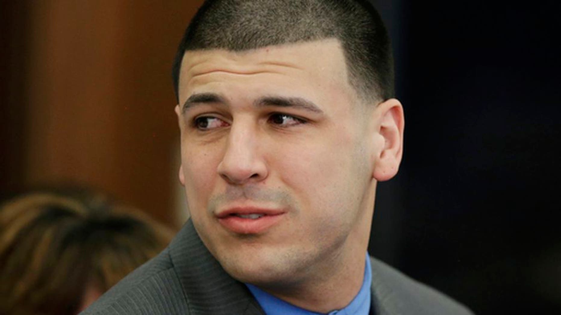 FILE - In this Friday, April 14, 2017, file photo, Former New England Patriots tight end Aaron Hernandez turns to look toward his fiancee Shayanna Jenkins Hernandez as he reacts to his double murder acquittal at Suffolk Superior Court in Boston. Hernandezs family is planning a private funeral for the former NFL star in his hometown in Bristol, Conn. A spokeswoman for the Connecticut Funeral Directors Association said Saturday, April 22, that the service is set for Monday, April 24. The former New England Patriots tight end was found hanged in his cell in a maximum-security prison in Massachusetts early Wednesday, April 19. (AP Photo/Stephan Savoia, Pool, File)