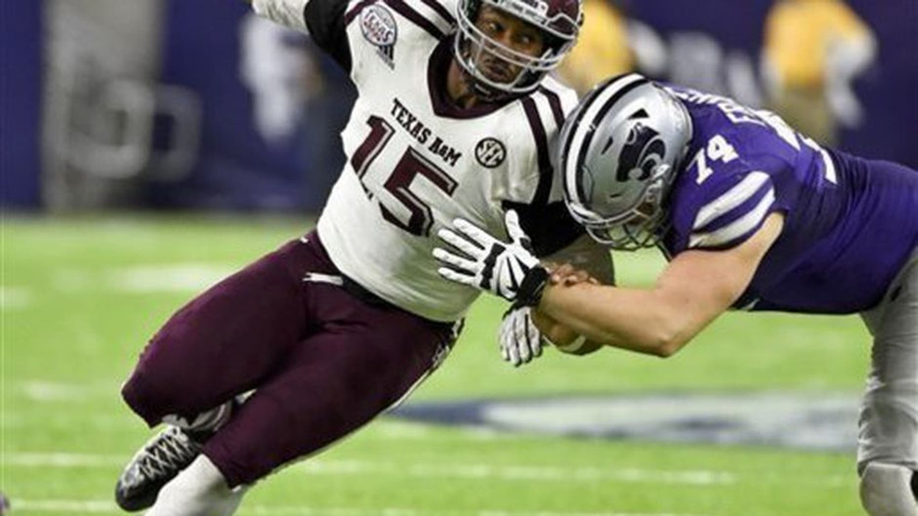 FILE - In this Dec. 28, 2016, file photo, Texas A&M's Myles Garrett (15) tries to get around Kansas State offensive lineman Scott Frantz during the second half of the Texas Bowl NCAA college football game in Houston.The NFL Draft will be held April 27-29, 2017, in Philadelphia. (AP Photo/Eric Christian Smith, File)
