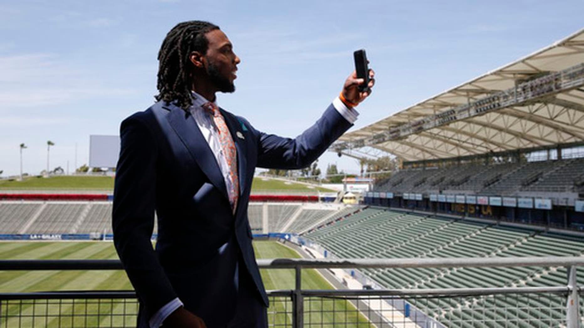 Los Angeles Chargers first-round draft pick Mike Williams records video for Snapchat after an NFL football news conference at the StubHub Center, Friday, April 28, 2017, in Carson, Calif. (AP Photo/Jae C. Hong)