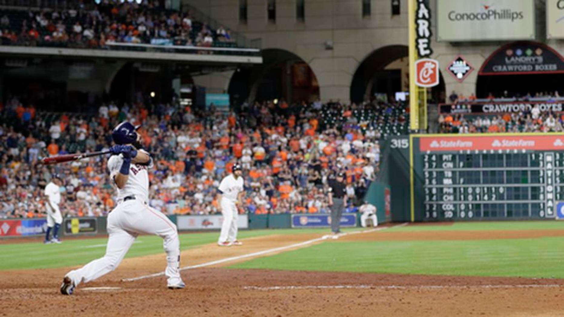 Houston Astros' Marwin Gonzalez hits a grand slam against the Texas Rangers during the eighth inning of a baseball game, Tuesday, May 2, 2017, in Houston. (AP Photo/David J. Phillip)